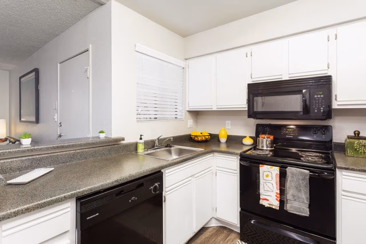 Kitchen with black appliances and white cabinets