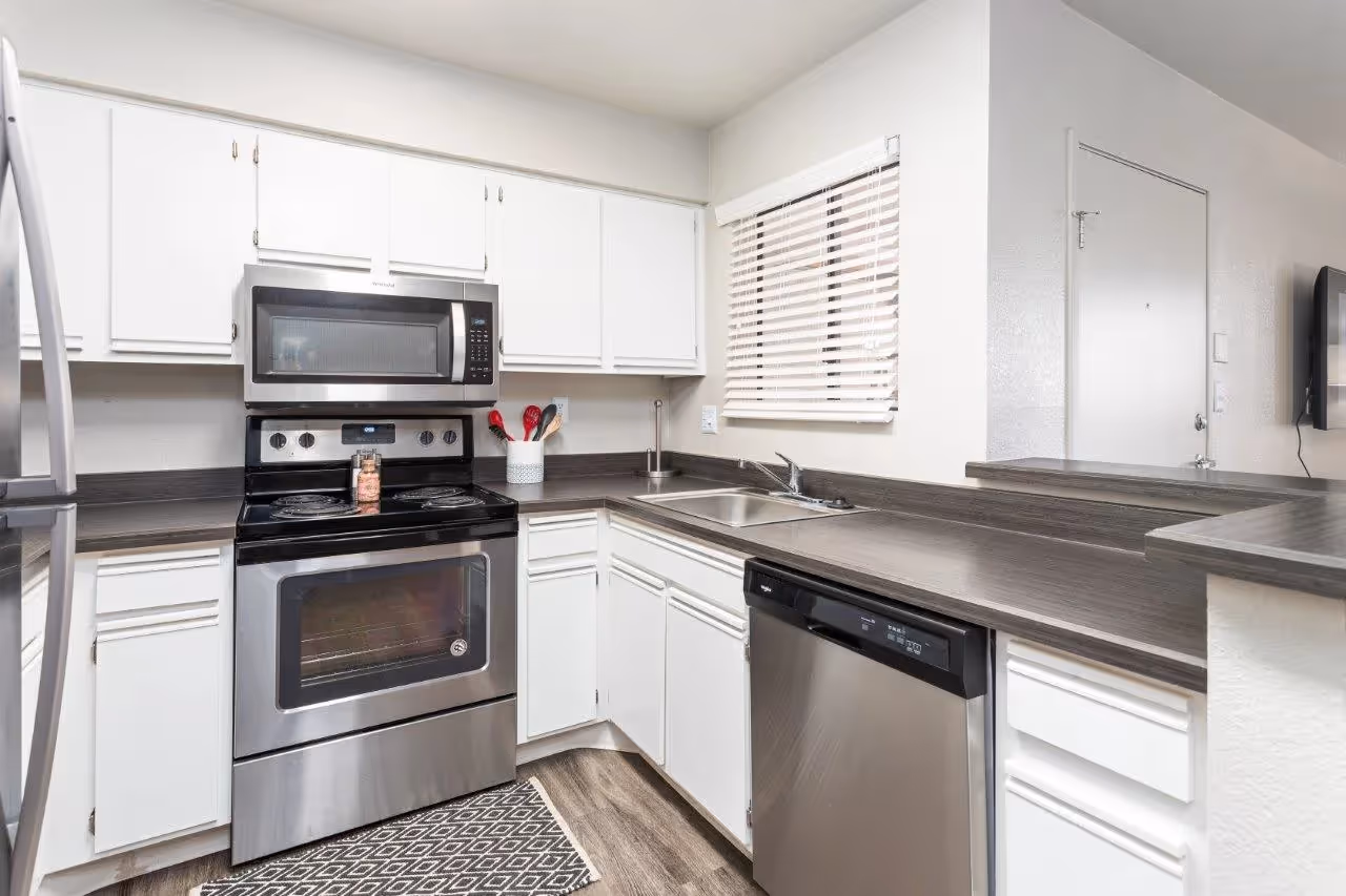 Kitchen with stainless steel appliances and white cabinets