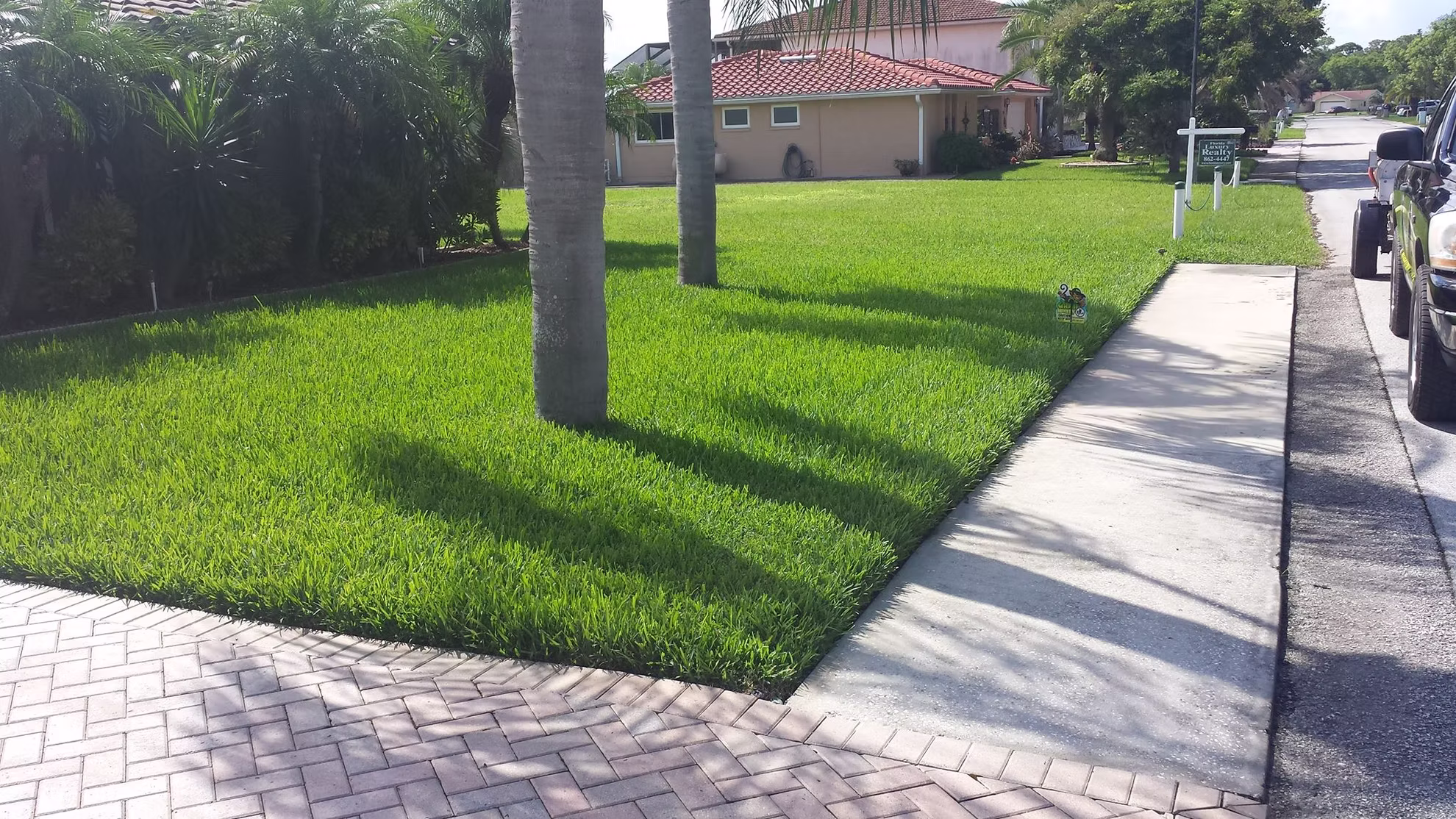 Grass Monkey technician treating a residential lawn in Tampa Bay