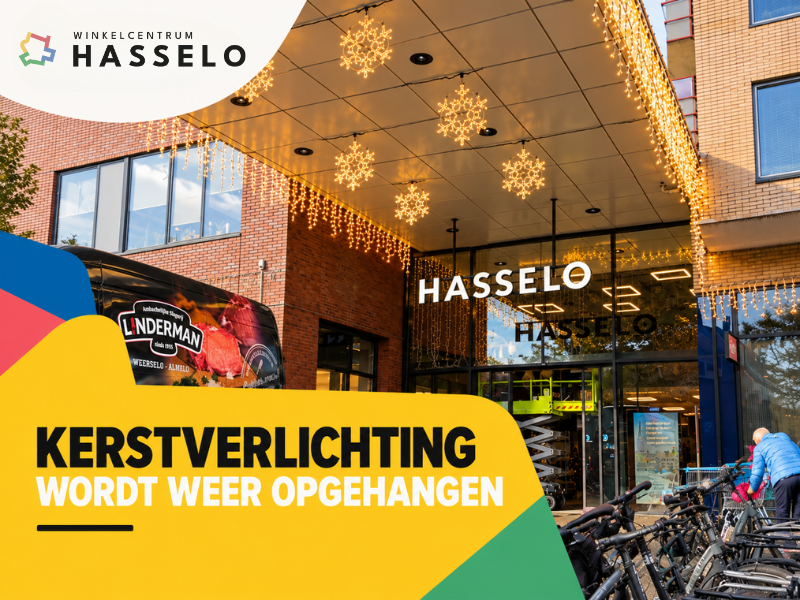 Kerstverlichting wordt opgehangen bij de ingang van Winkelcentrum Hasselo