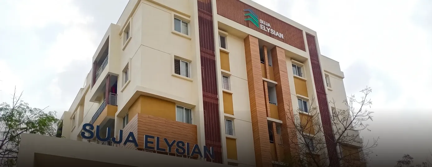 Facade of a modern multi-story building with the name Suja Elysian displayed prominently.