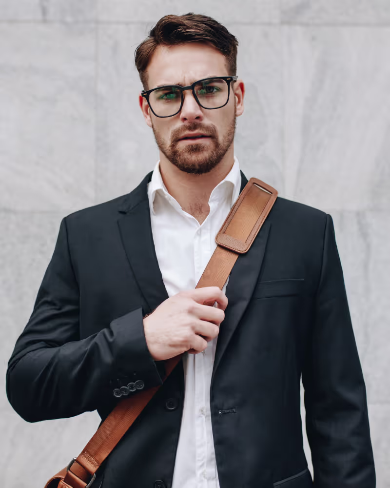 Man carrying bag in suit.