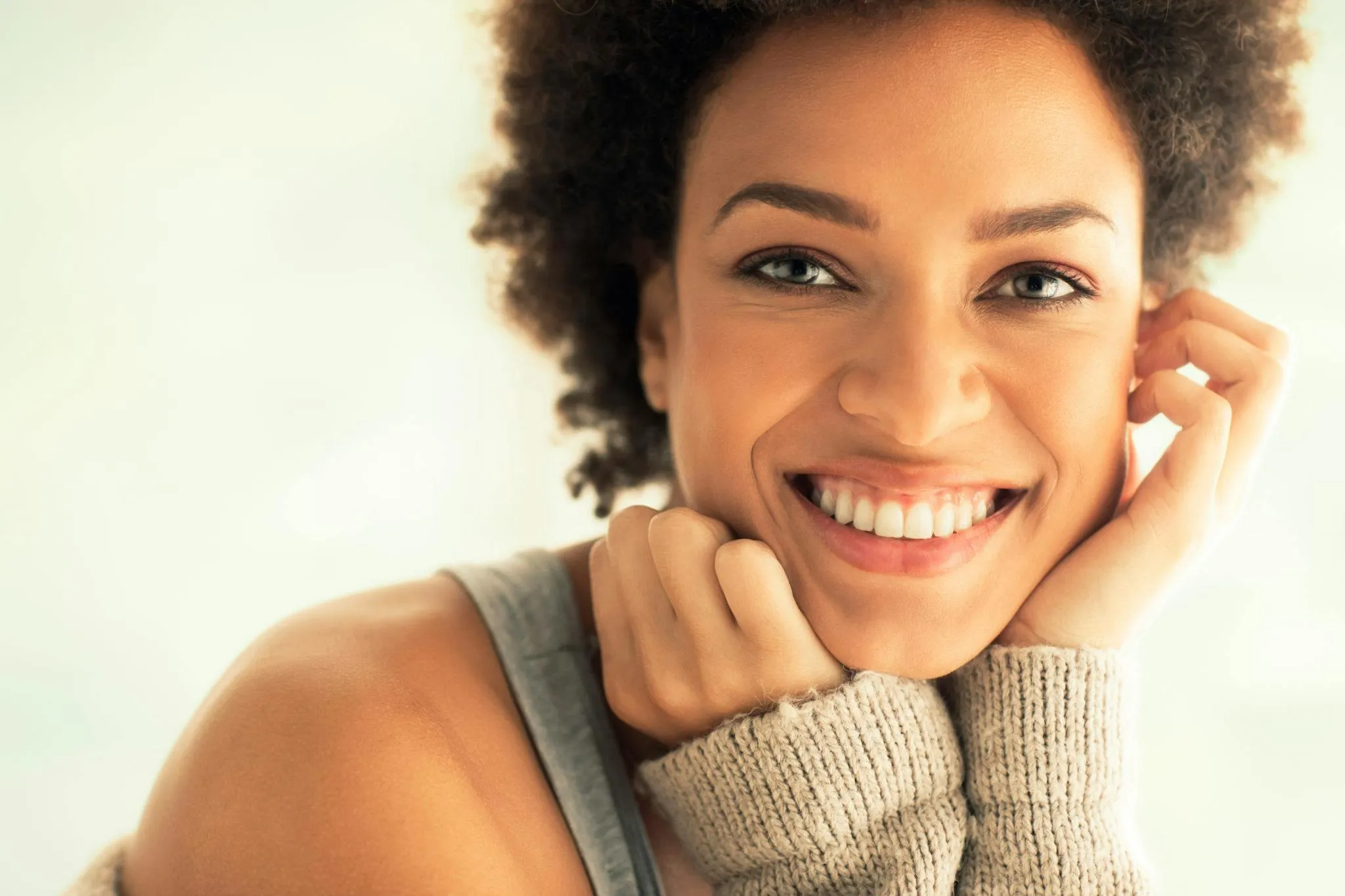 woman smiling with long sleeve sweater