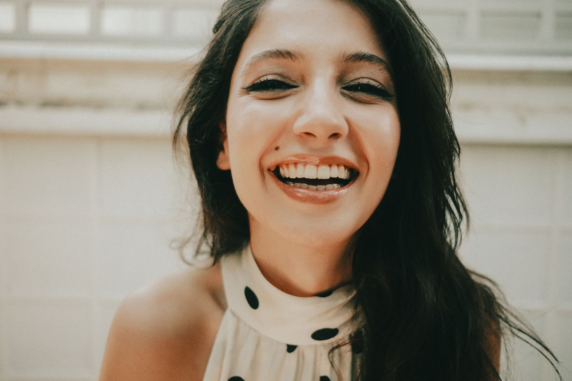 Woman laughing with a bright, natural smile