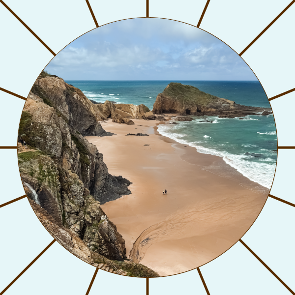 Sandy beach with rocky cliffs and ocean waves under a partly cloudy sky, viewed from an elevated path.