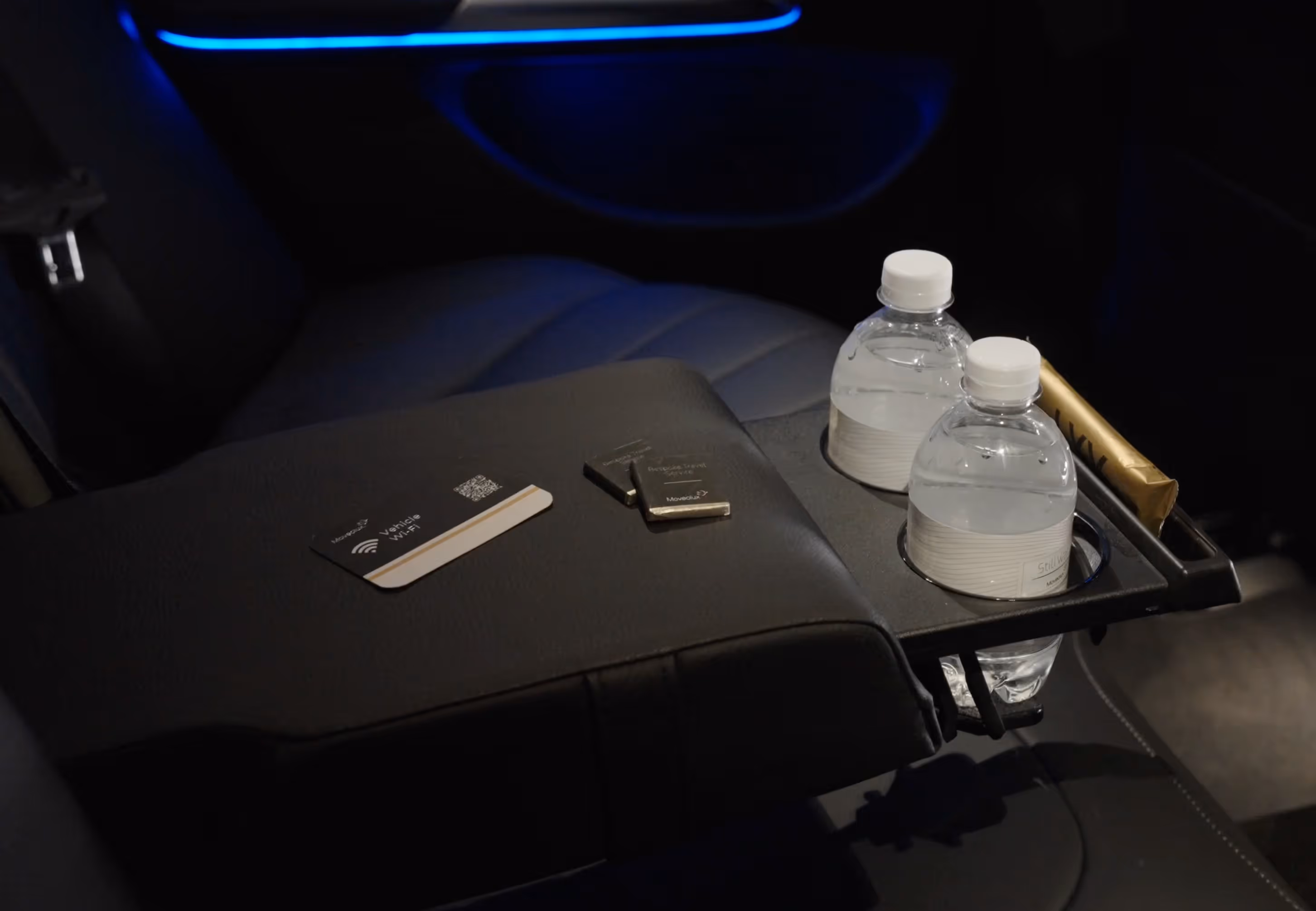 Onboard amenities detail inside the Mercedes E-Class with water and travel essentials