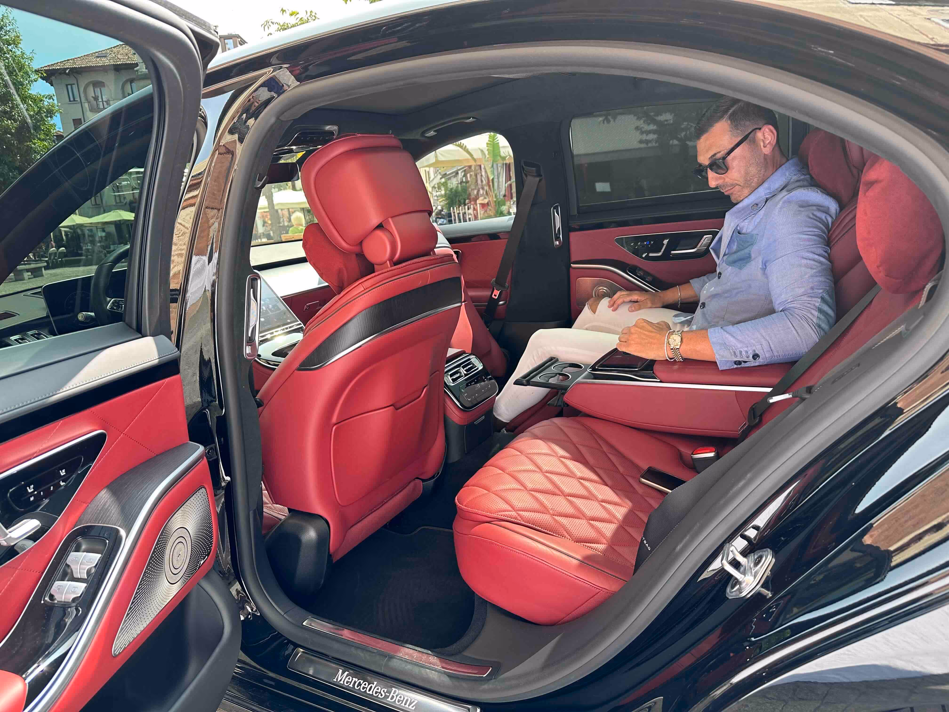 Rear passenger cabin of the Mercedes S-Class with red leather seats and executive comfort