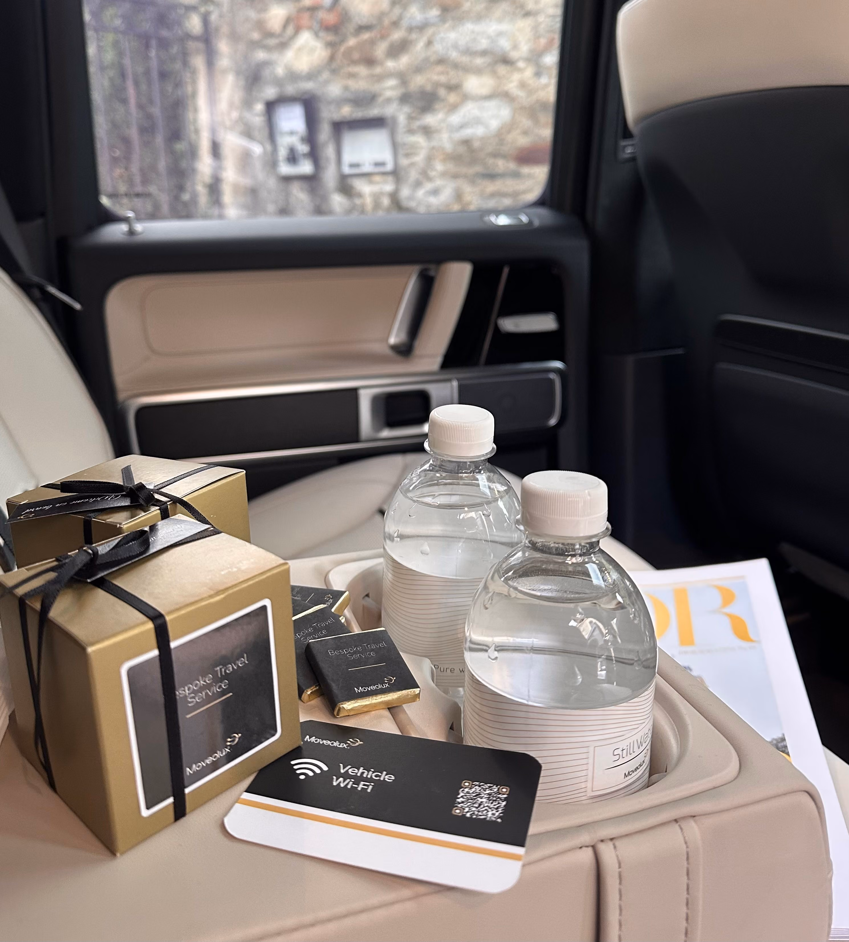 Onboard amenities inside the Mercedes AMG G-Wagon with water and premium travel essentials