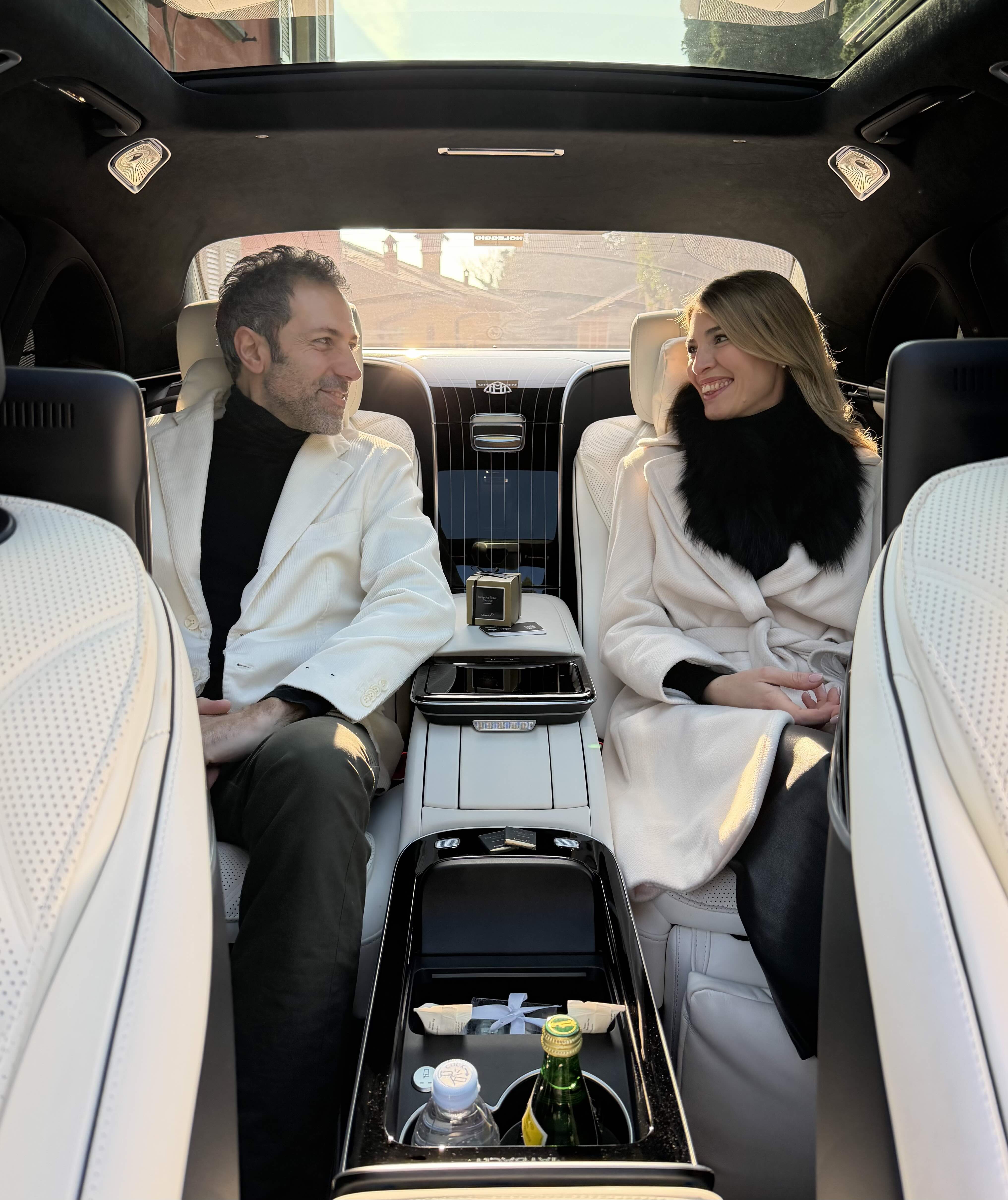 Couple seated inside the Mercedes Maybach S-Class rear cabin during a luxury chauffeur service