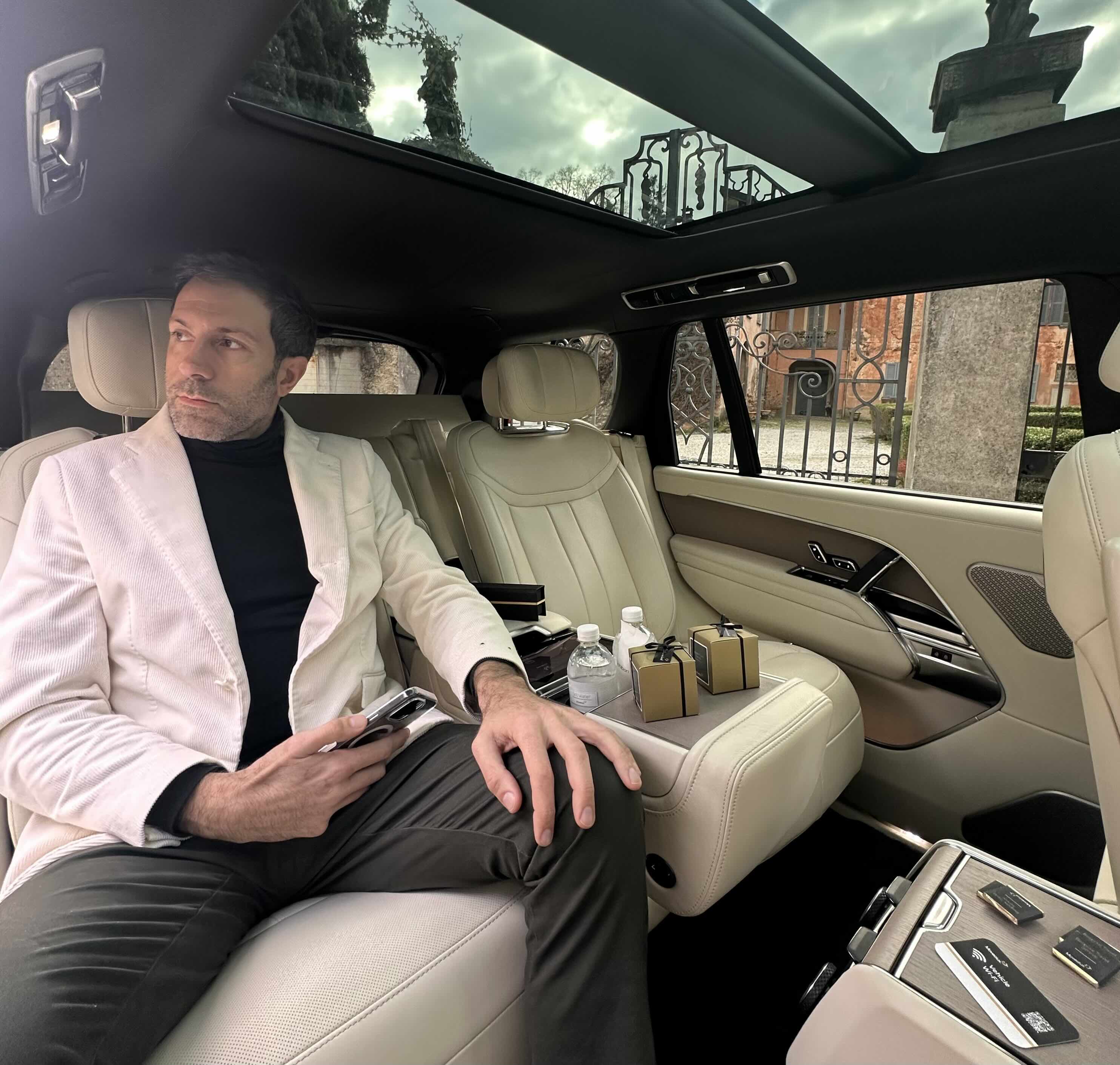 Passenger enjoying the rear cabin comfort of the Range Rover Autobiography chauffeur service
