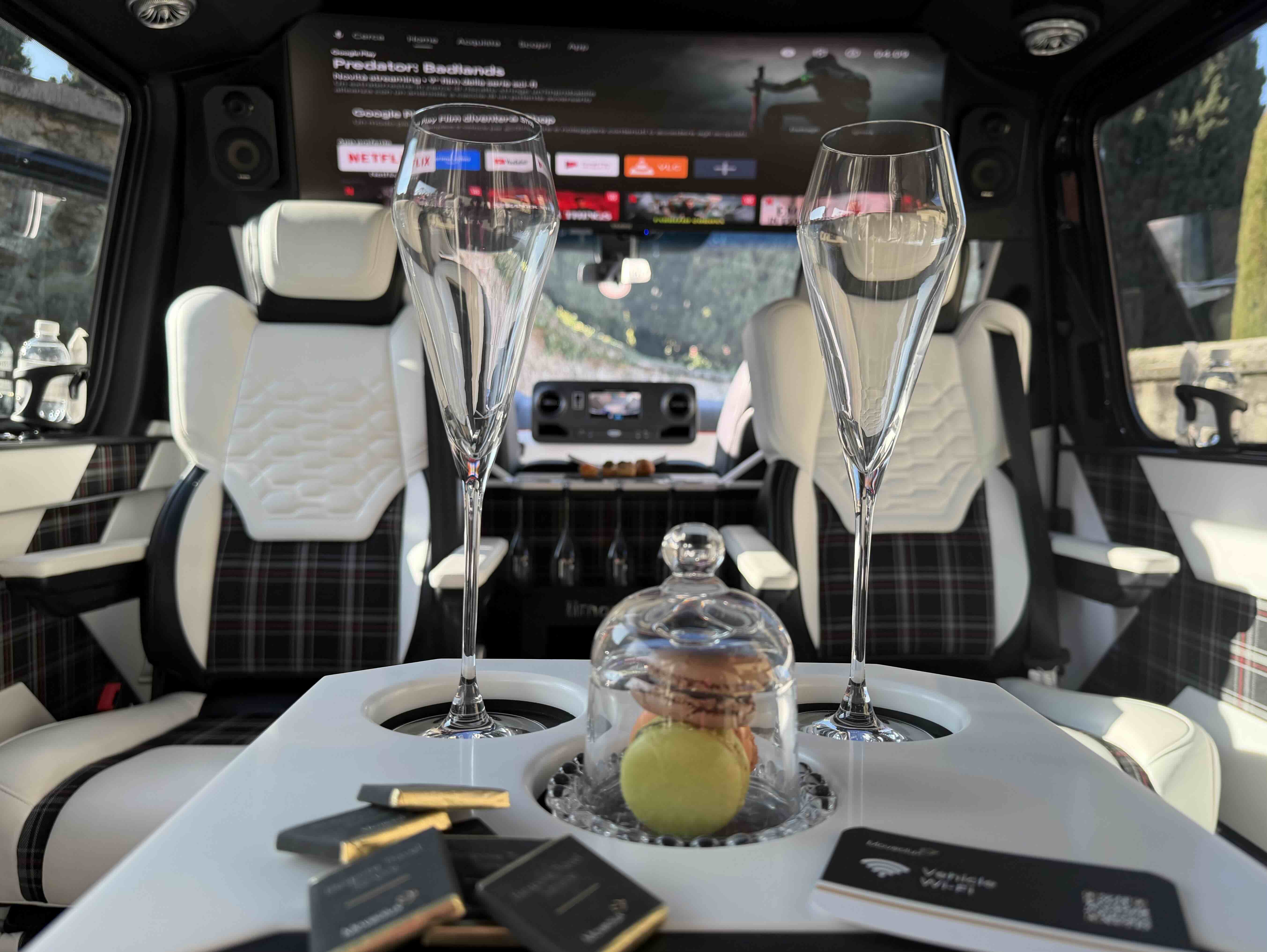 Luxury lounge interior of the Moveolux Limovan Portofino with premium seats and onboard screen