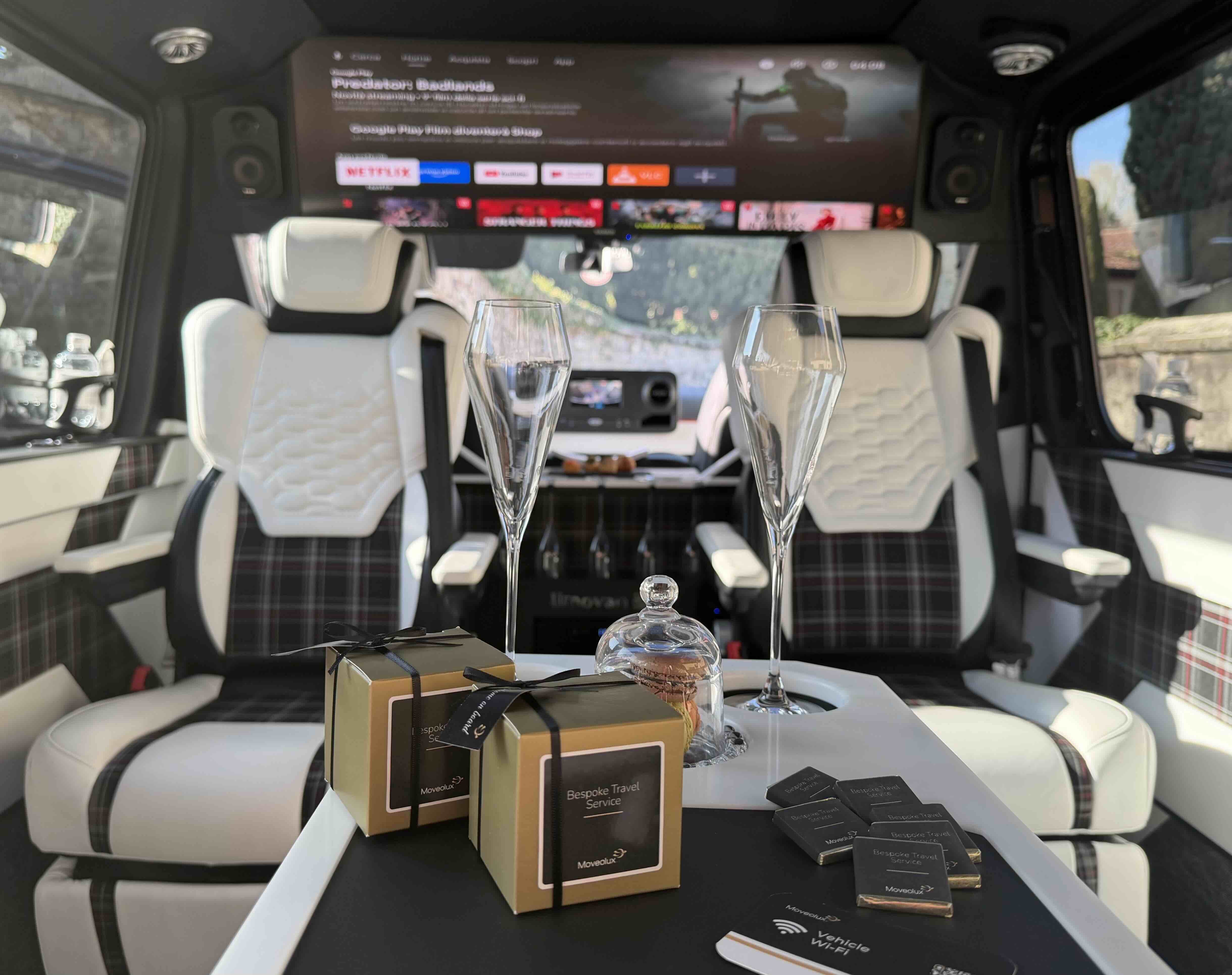 Premium cabin layout inside the Moveolux Limovan Portofino with table and luxury amenities