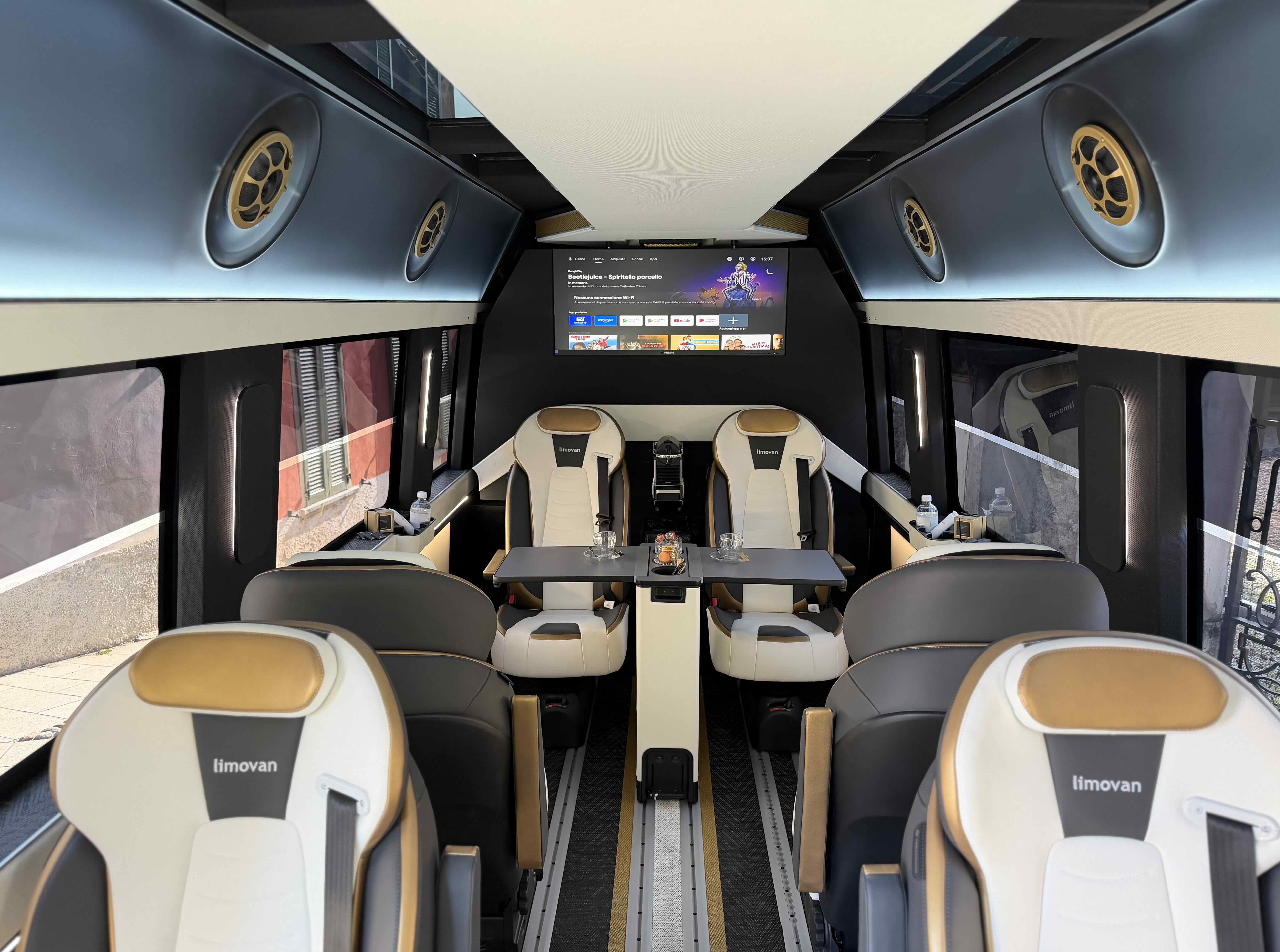 Luxury lounge interior of the Moveolux Limovan Black Edition with premium seats and onboard screen