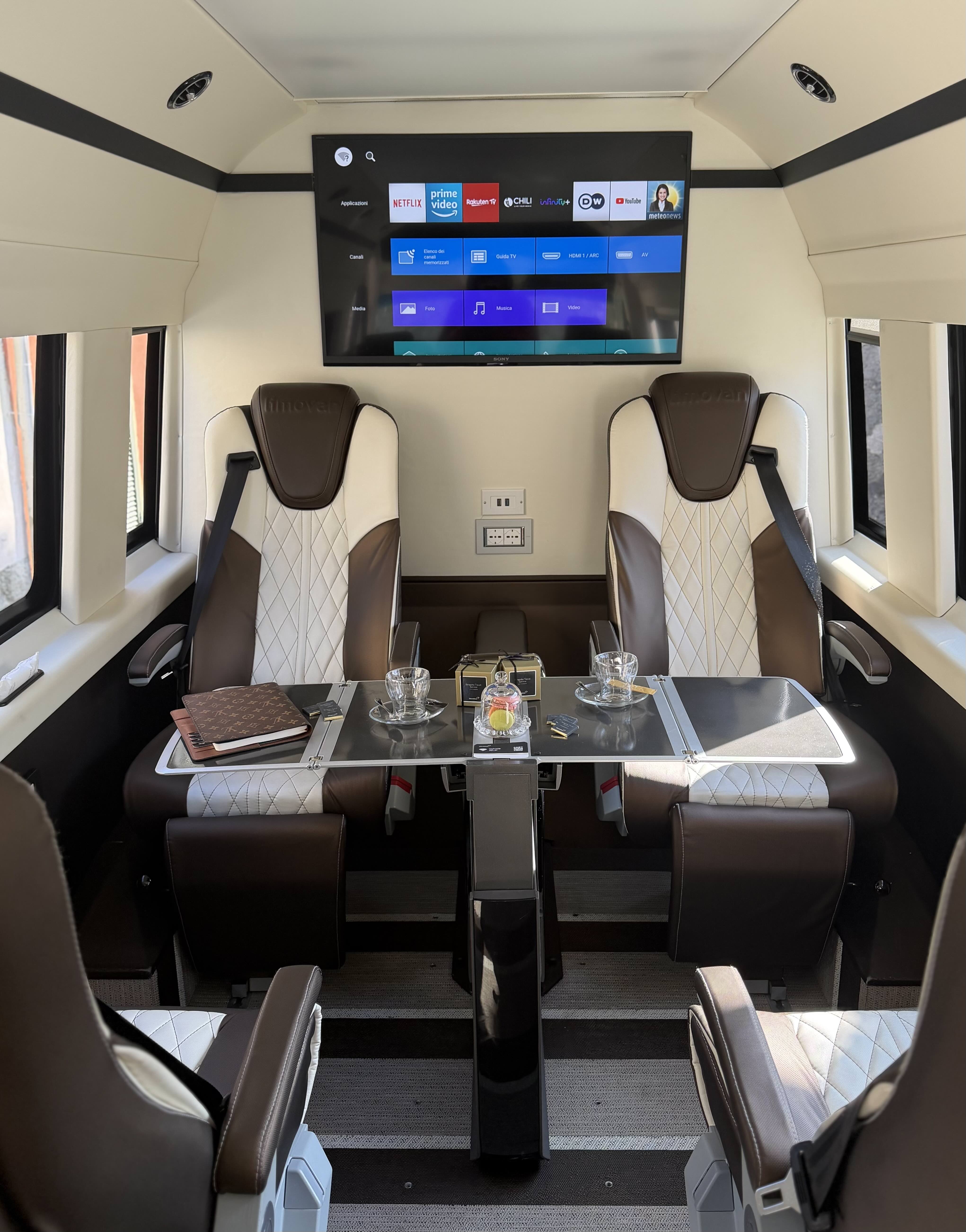 Premium cabin layout inside the Moveolux Limovan Light Edition with screen and executive seats