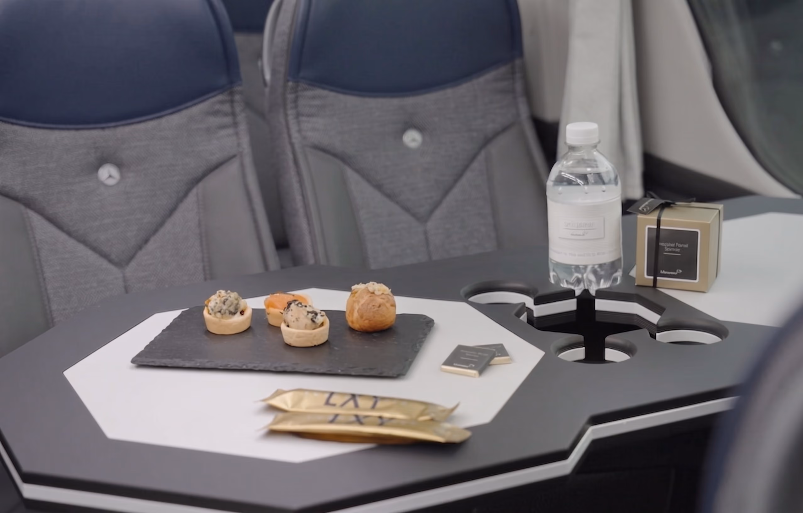 Aperitif table detail inside the Moveolux Luxury Minibus 19 with premium onboard amenities