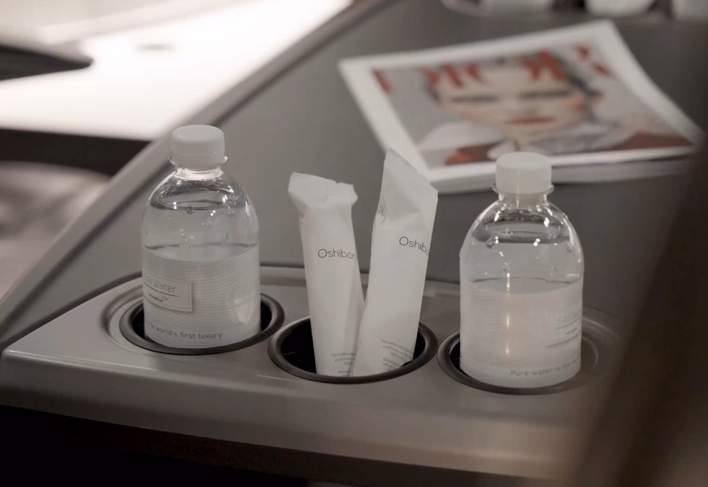 Onboard amenities inside the Moveolux Luxury Bus 28 with water and premium travel essentials