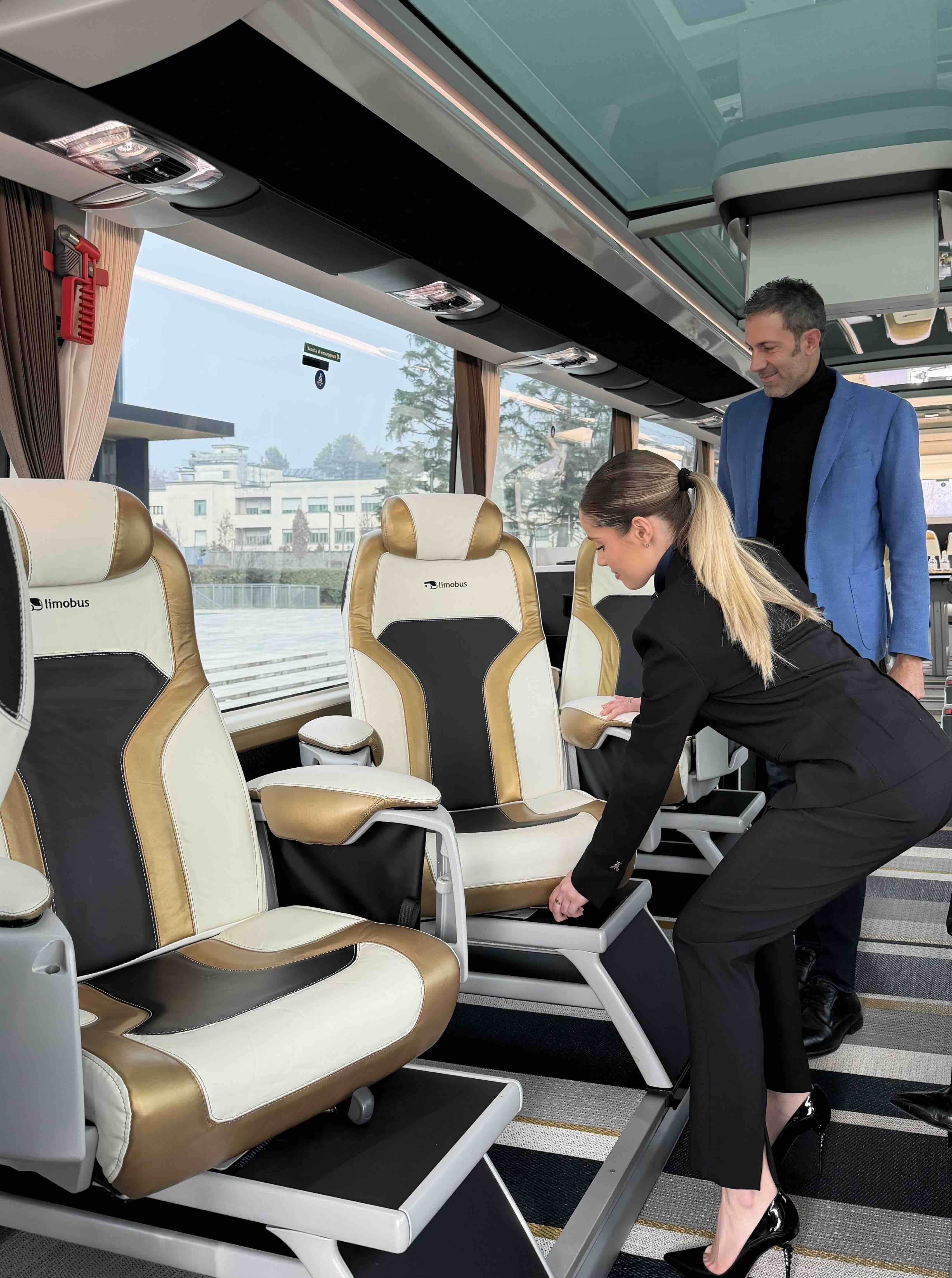 Hostess passenger service inside the Moveolux Limobus Individuals 28 for elevated group mobility