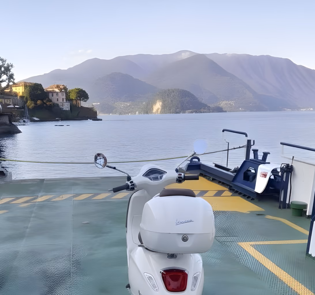 Vespa Primavera 125 by Lake Como ferry area for scenic scooter rental and local travel