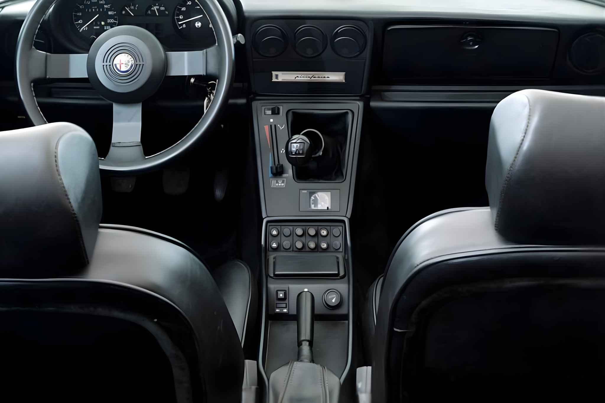 Interior view of the Alfa Romeo Duetto IV Spider with steering wheel, dashboard and center console