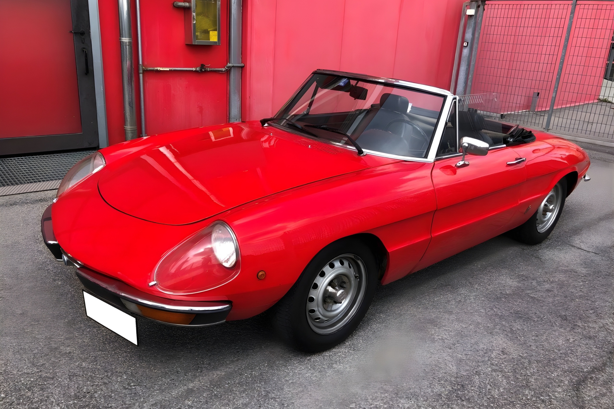Front side view of the red Alfa Romeo Duetto IV Spider for Italian-style touring