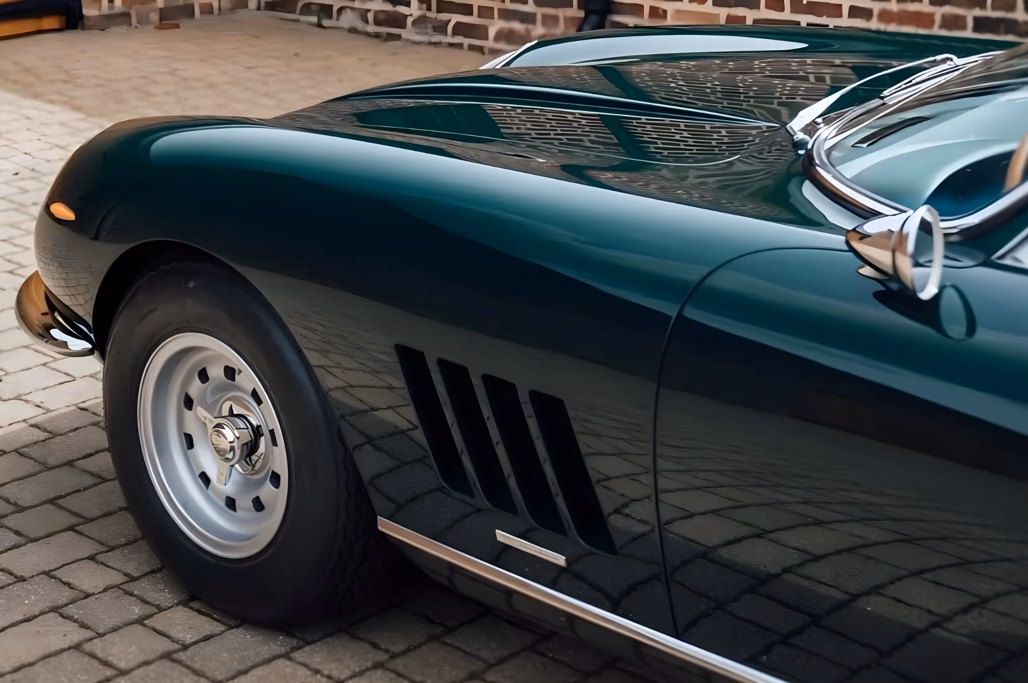 Side vent detail of the Ferrari 275 GTB with green bodywork and classic Italian styling