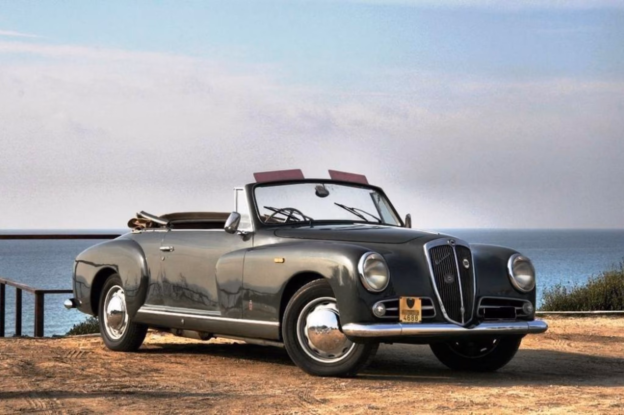 Lancia Aurelia B50 with driver by the sea for formal events and timeless chauffeured travel