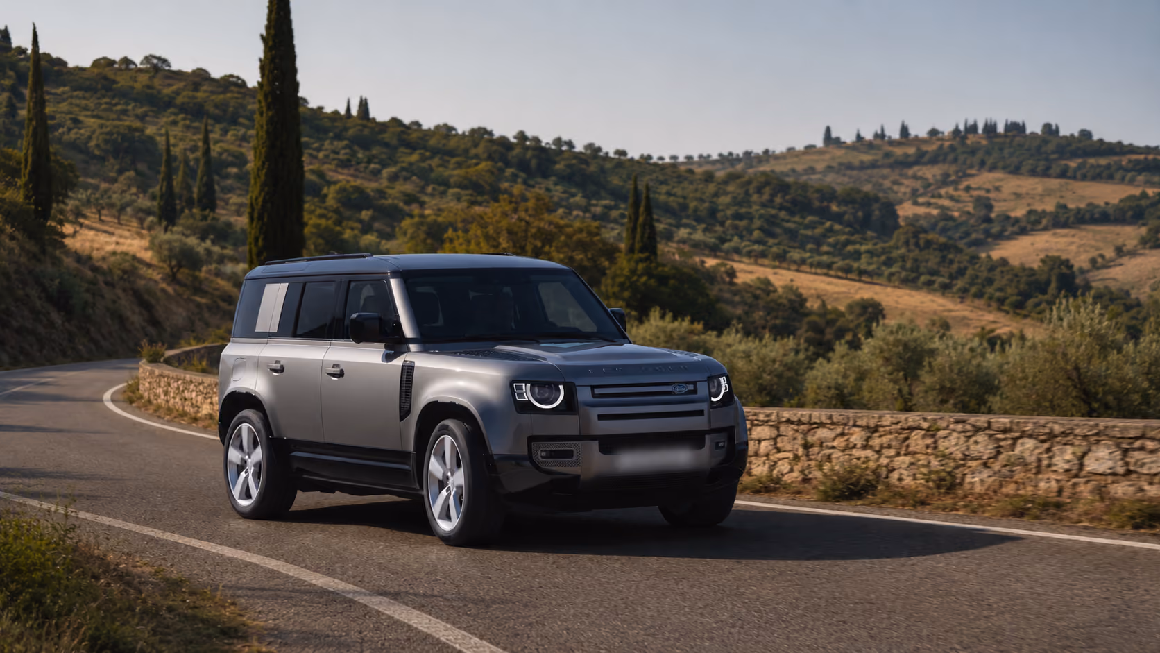 Range Rover Performance SUV driving on a countryside road for premium self-drive journeys