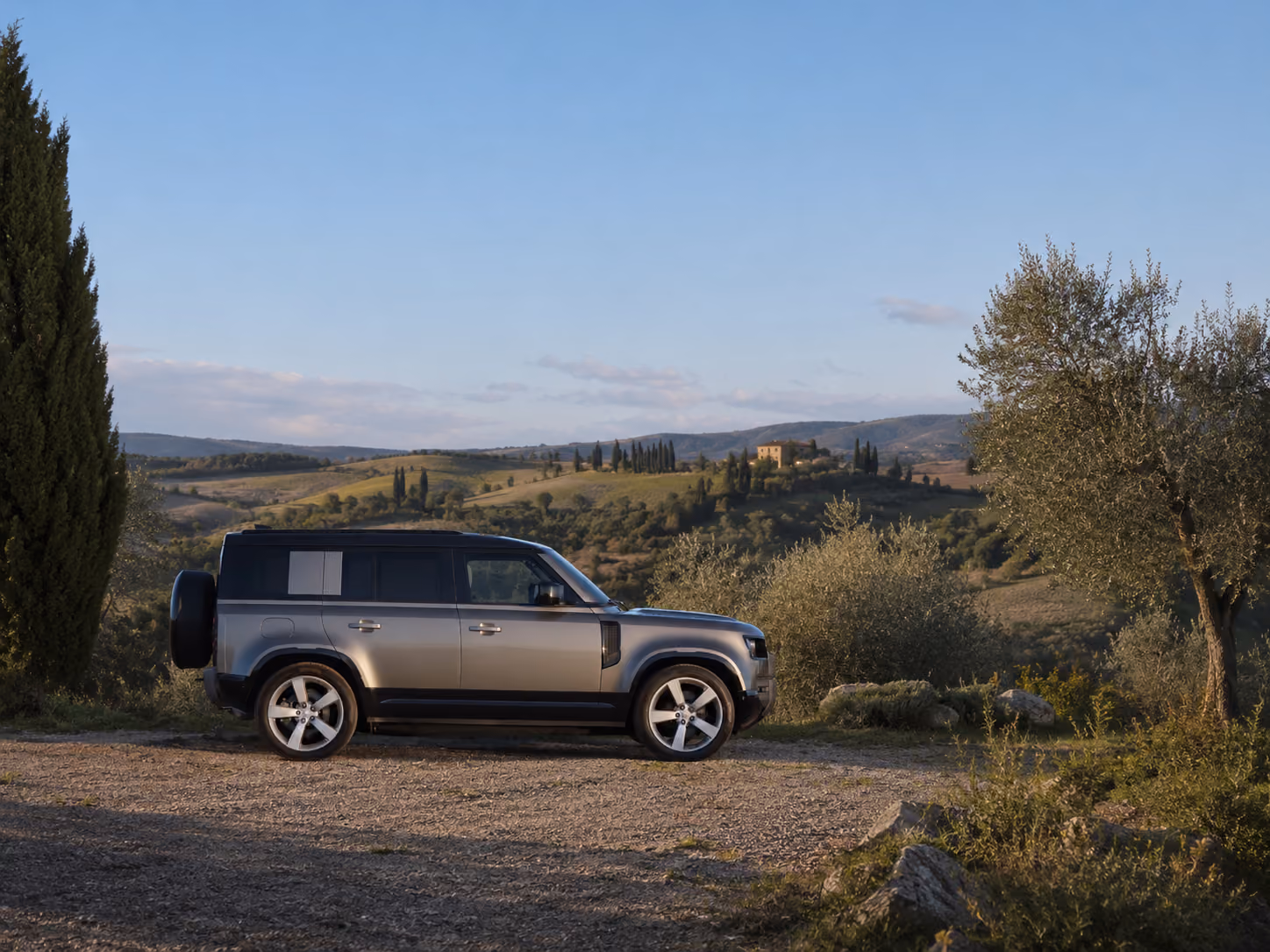 Side profile of the Range Rover Performance SUV in the countryside for premium self-drive travel
