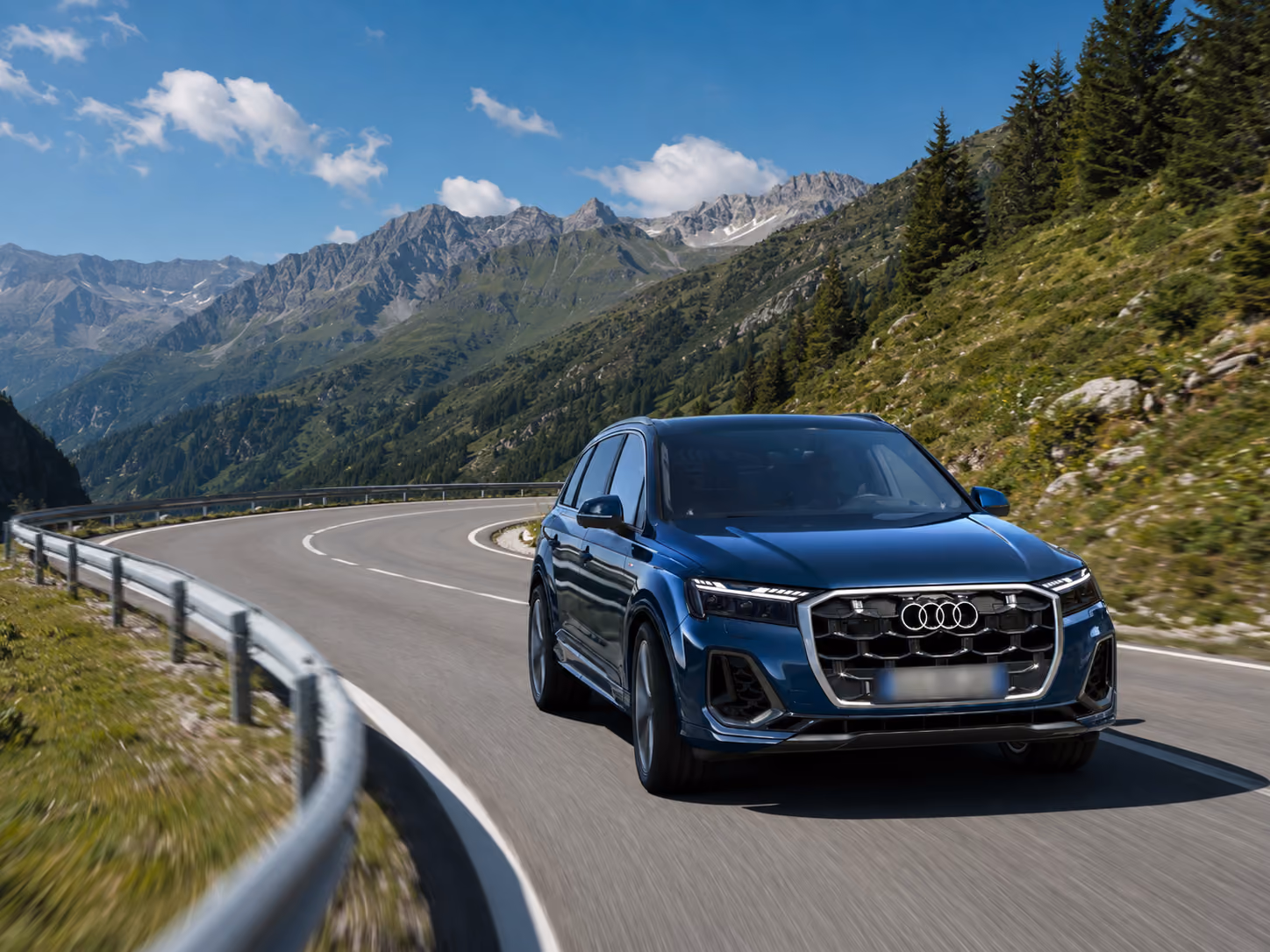 Front view of the Audi Performance SUV on a scenic mountain road for luxury self-drive rental