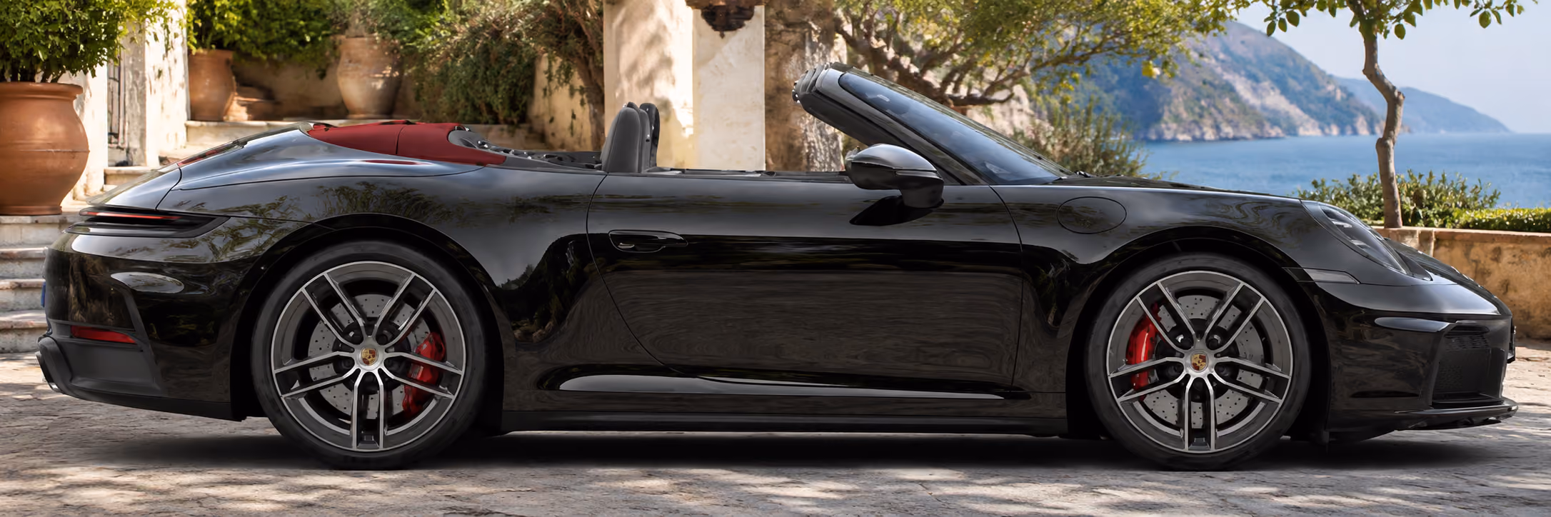 Side profile of a Porsche iconic convertible car for premium self-drive open-air travel