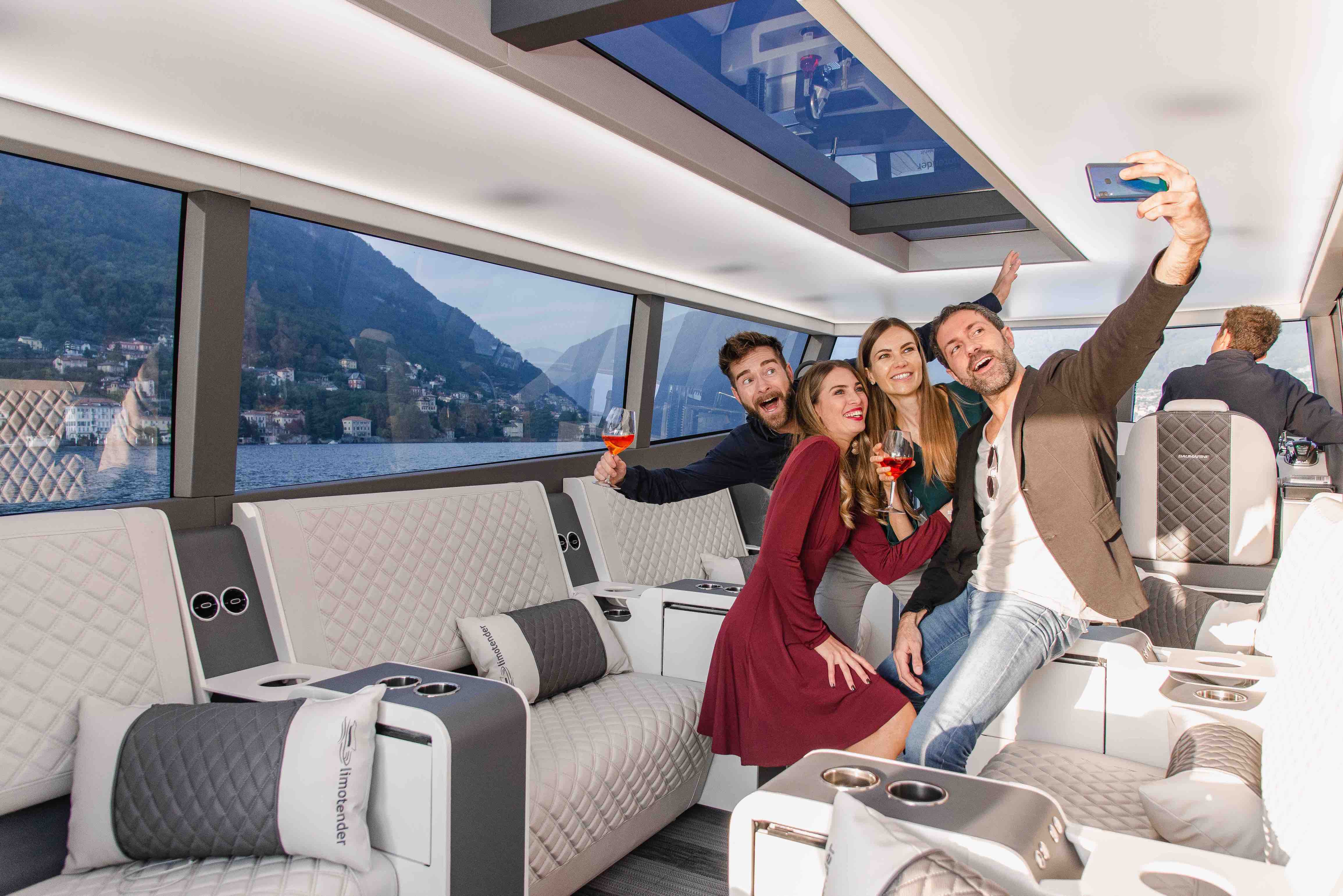 Group selfie inside the Moveolux Limotender lounge during a premium private boat experience