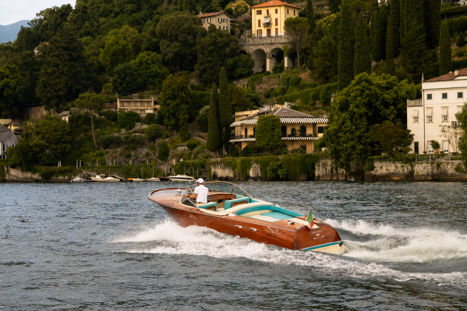 Riva boat cruising on Lake Como near lakeside villas for exclusive private tours