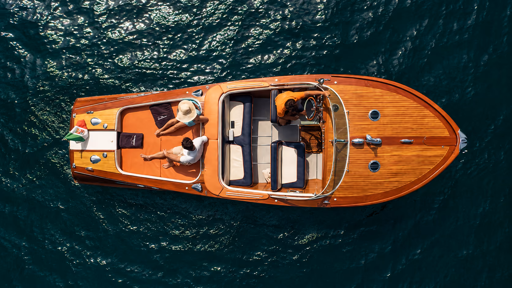 Top view of a Riva boat with passengers on Lake Como for a private luxury cruise