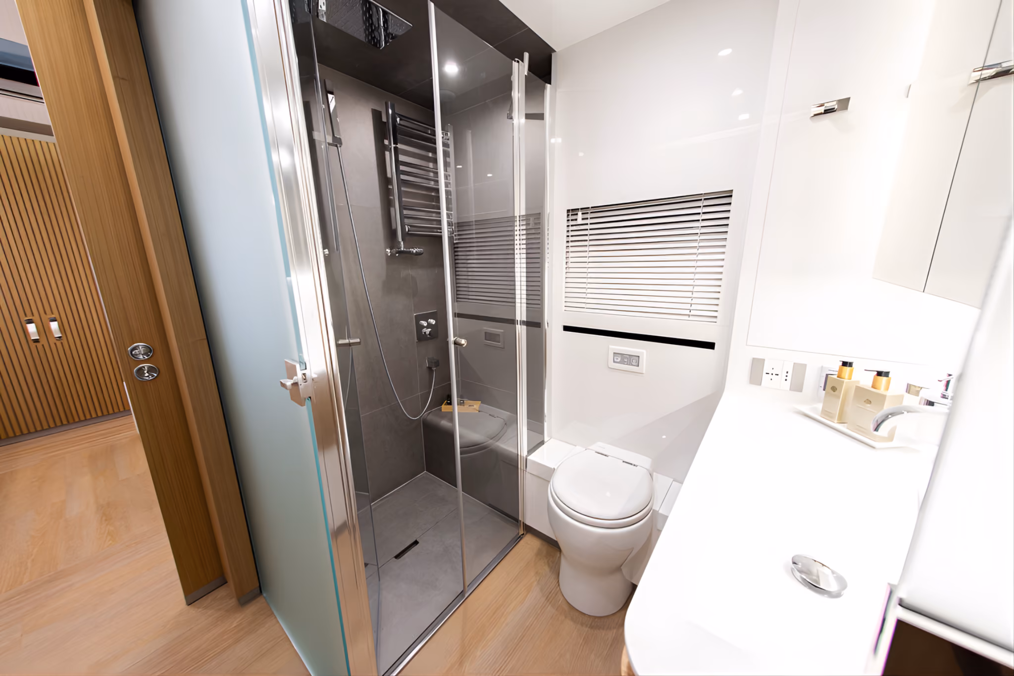 Bathroom inside the Mercedes Actros STX luxury motorhome with shower and premium amenities