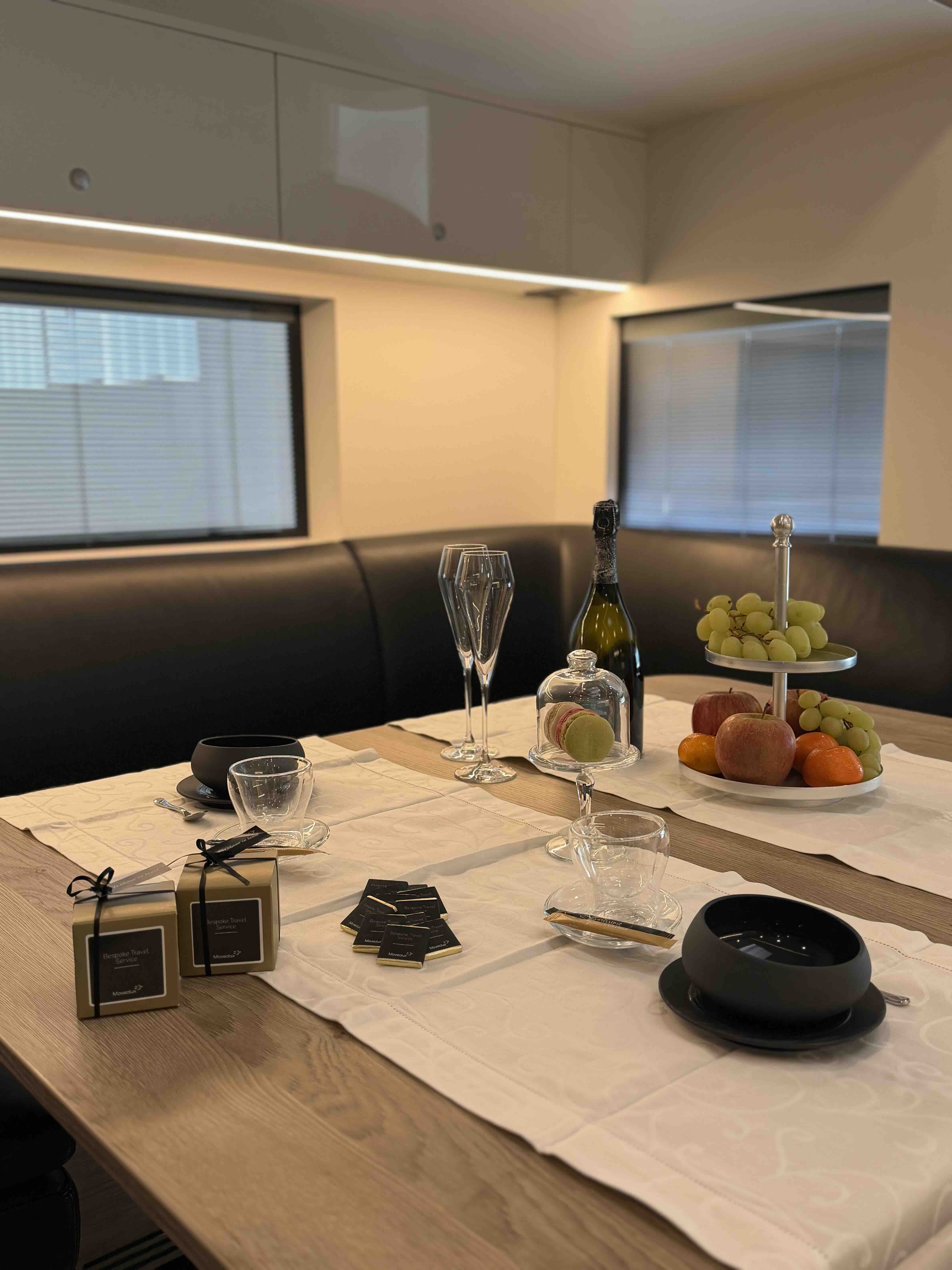 Dining table inside the Mercedes Actros STX luxury motorhome for refined mobile hospitality