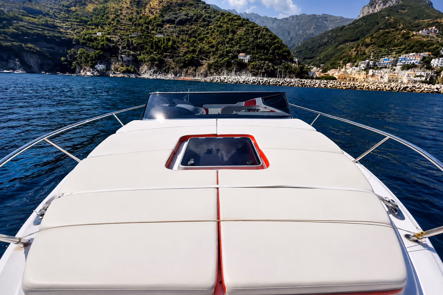 Bow view of an Amalfi taxi boat approaching the coastline during a private sea transfer