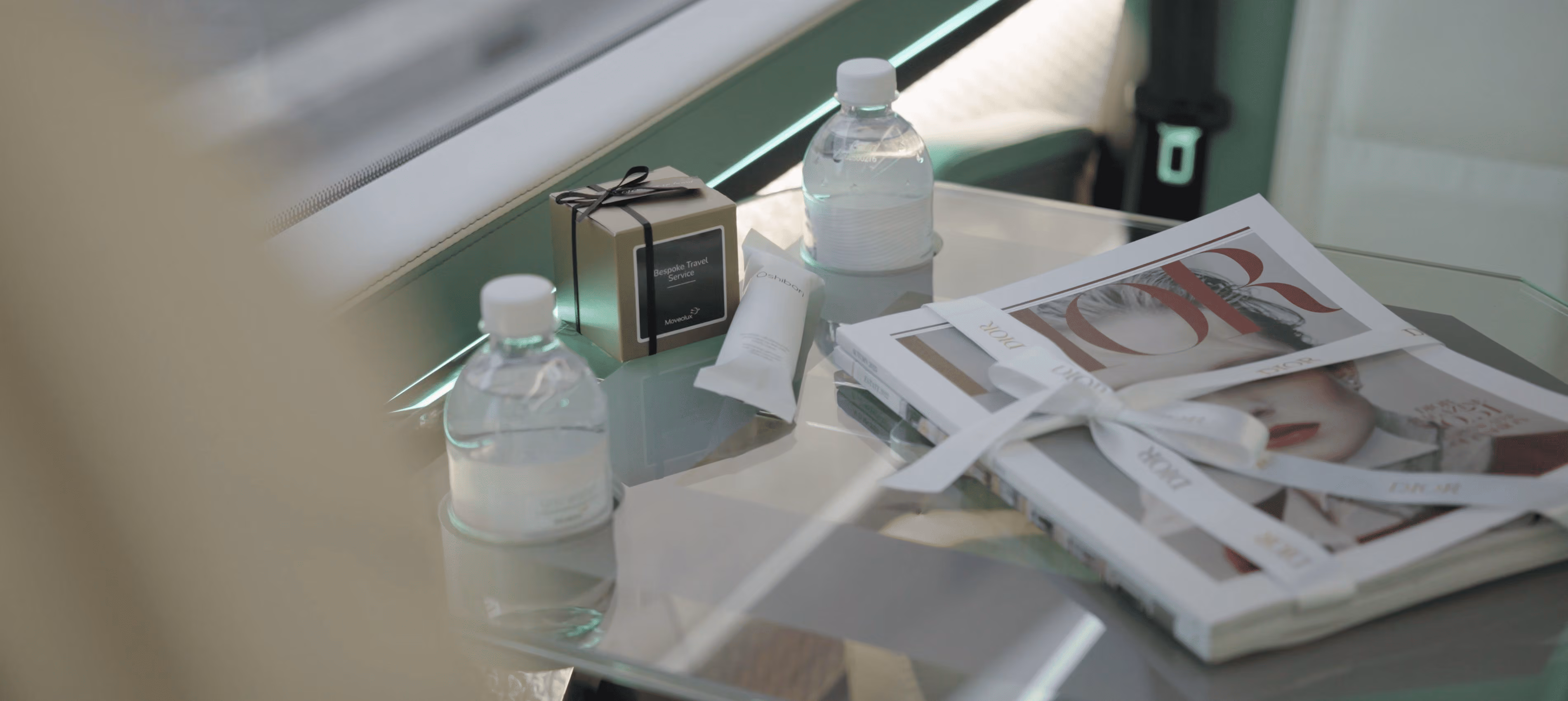Refreshments table detail on board the Moveolux Limobus Seabreeze 18 with water and magazines