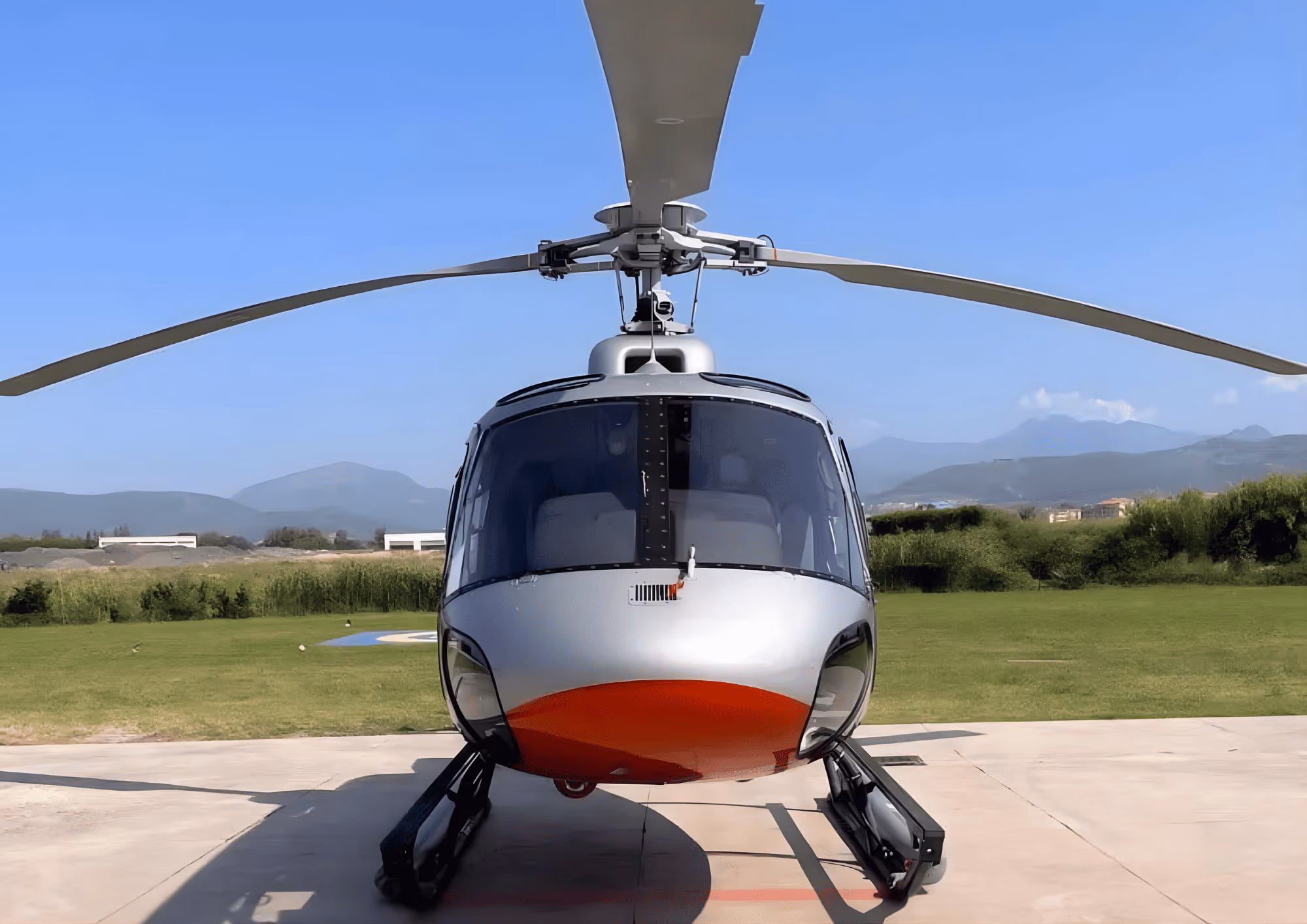 Front exterior view of the Airbus H125 helicopter ready for private transfer service