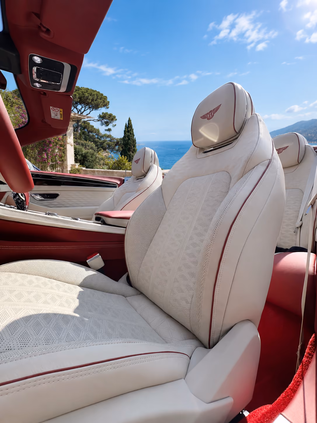Premium front seats inside a Bentley iconic convertible car with refined white leather interior