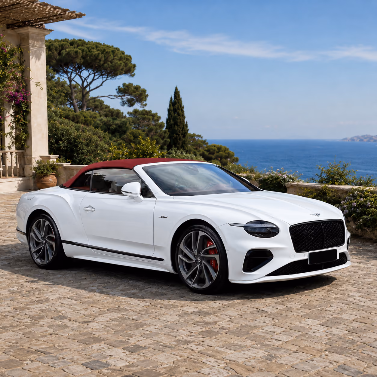 Front side exterior view of a Bentley iconic convertible car in an elegant coastal setting