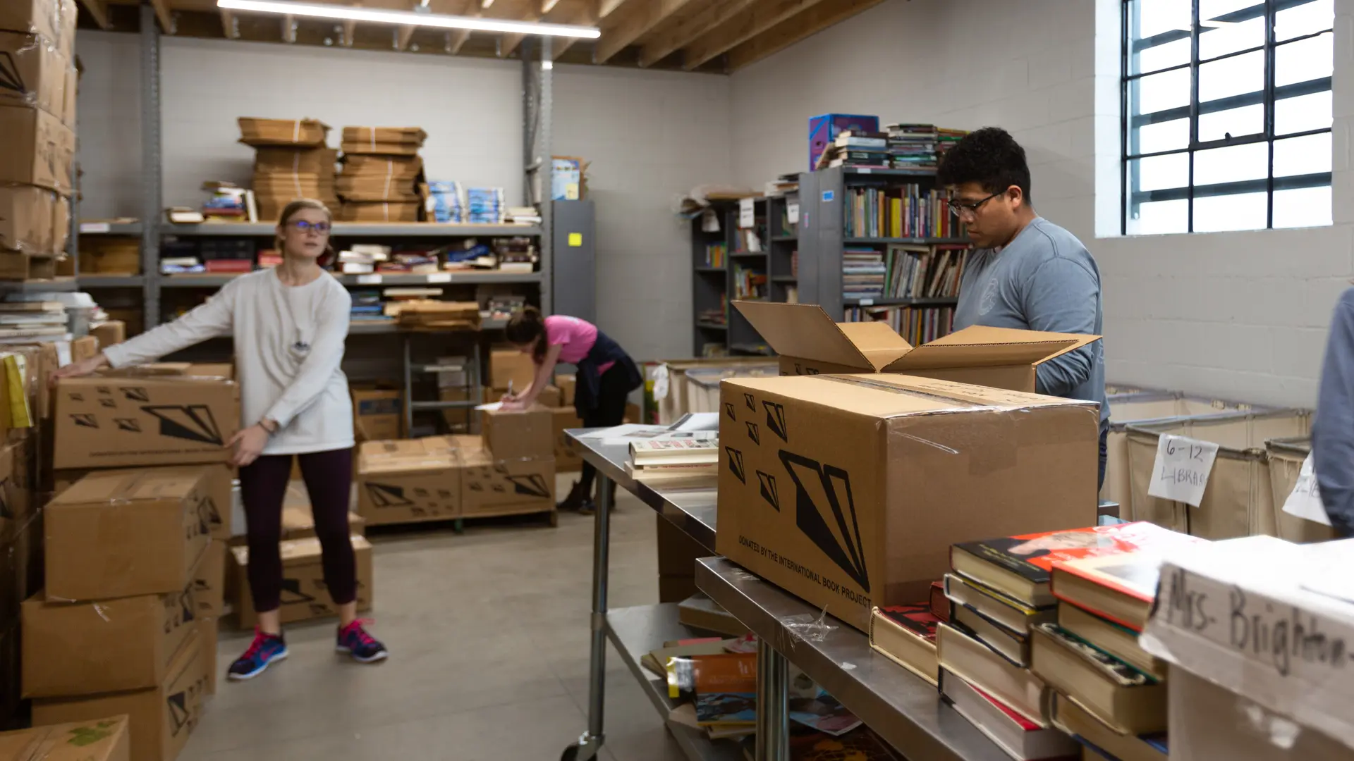 People packing boxes with books