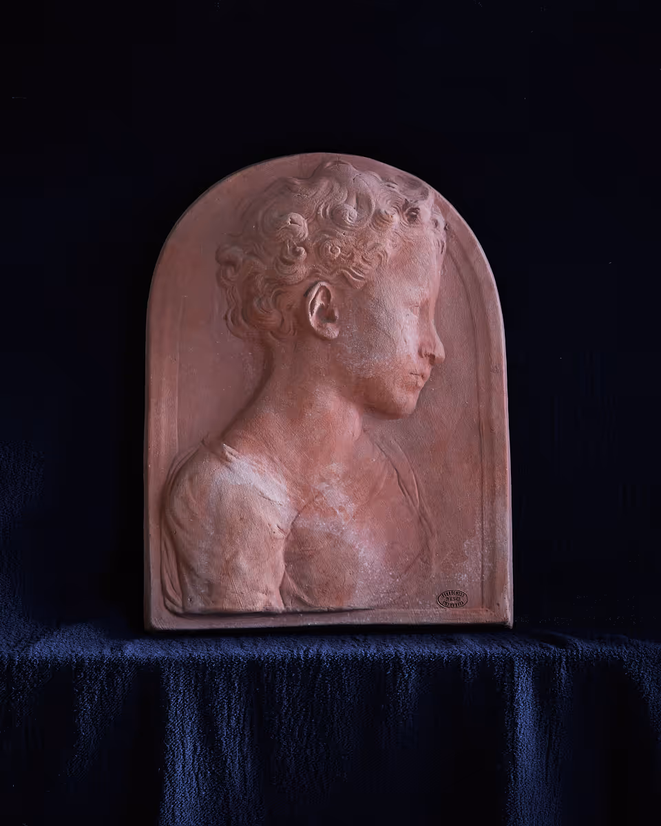 Portraying a young boy in delicate profile, the San Giovannino plaque balances Renaissance introspection with the strength of Impruneta clay.