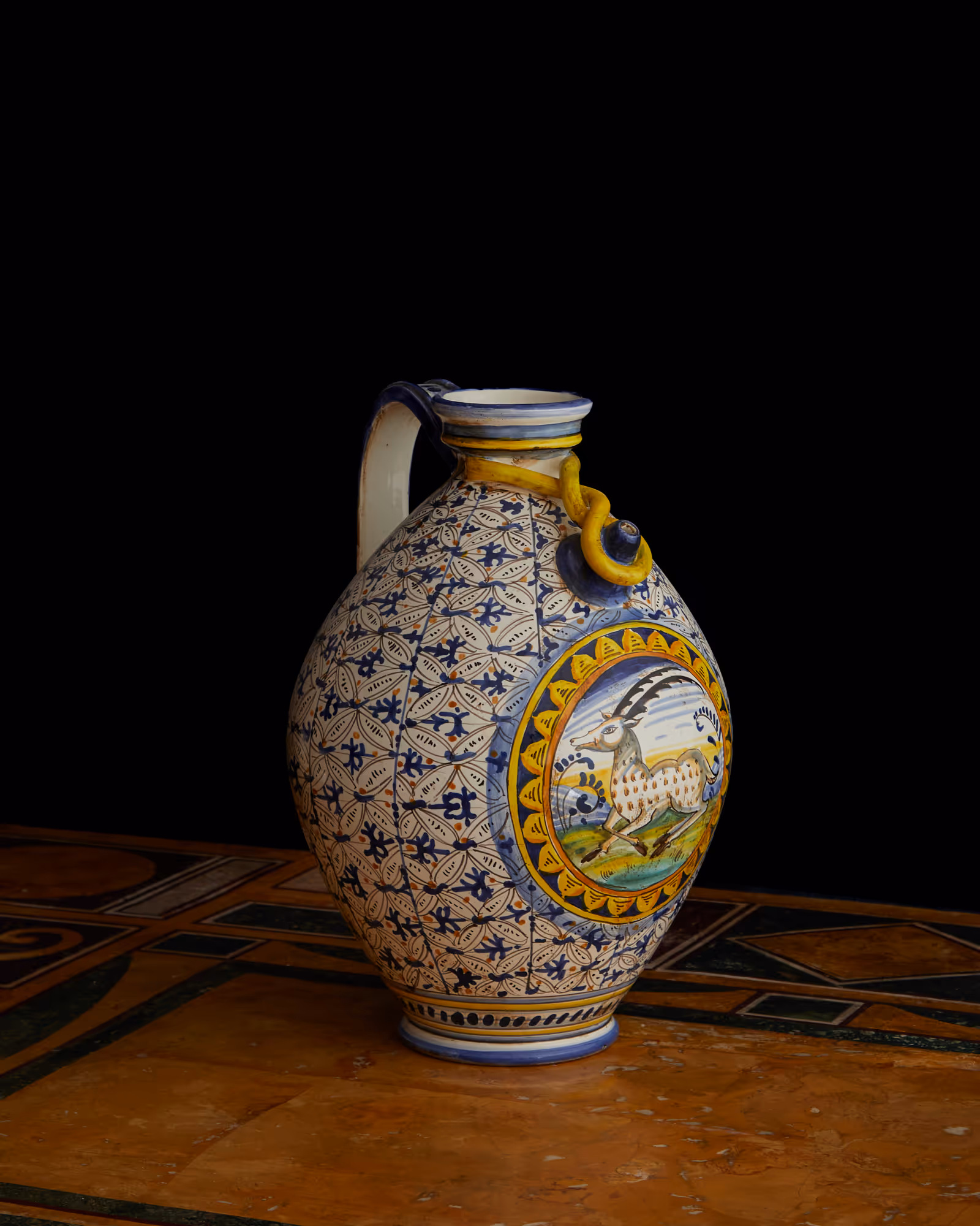 An ornate Montelupo pouring jar featuring a central gazelle medallion and complex geometric patterning; a striking display of wealth.