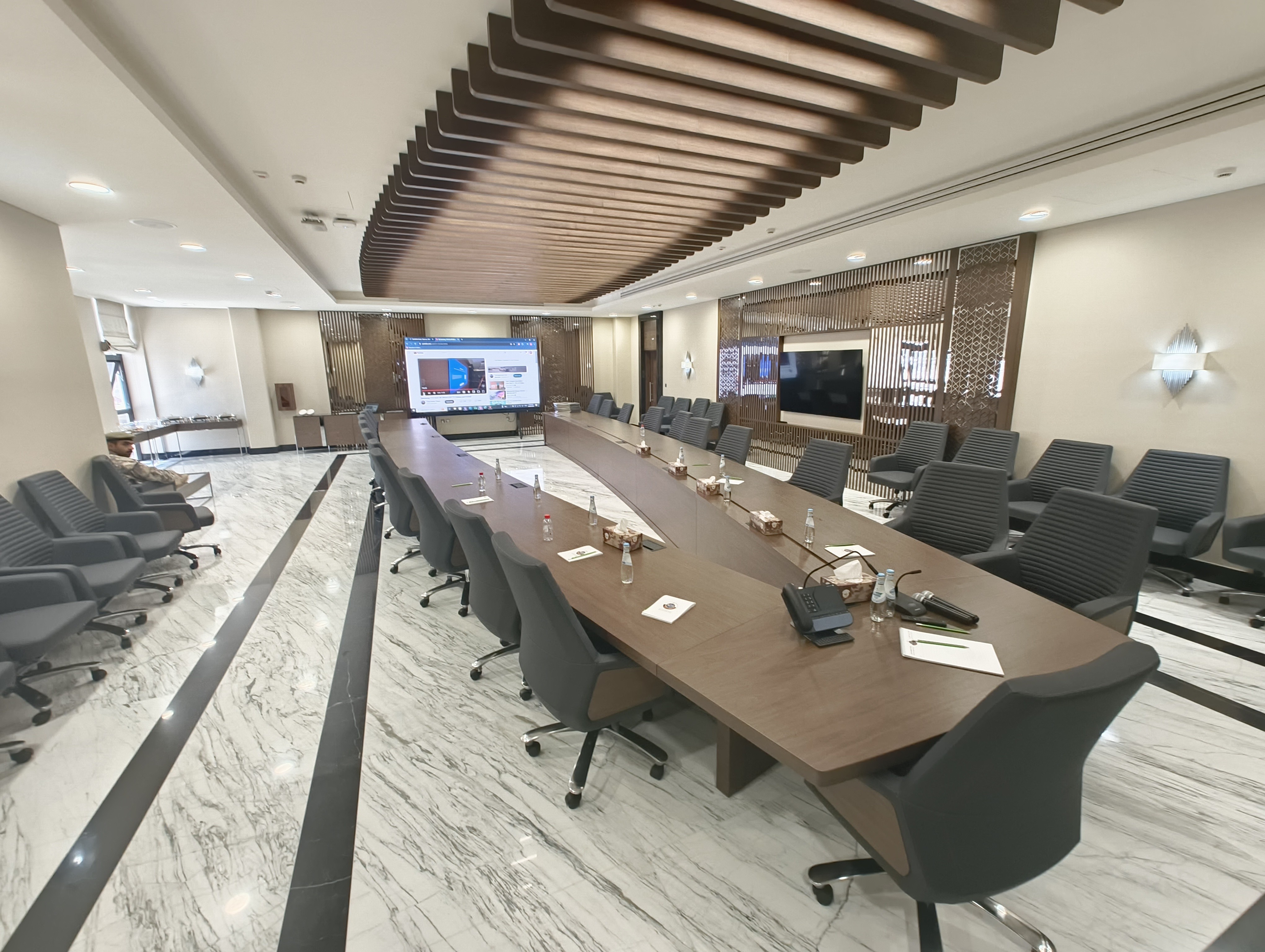 Boardroom with large wall-mounted display installed by Technobriq