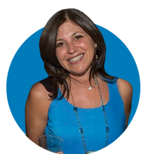 A woman smiles, wearing a blue top and necklace. She is positioned against a solid blue circular background.