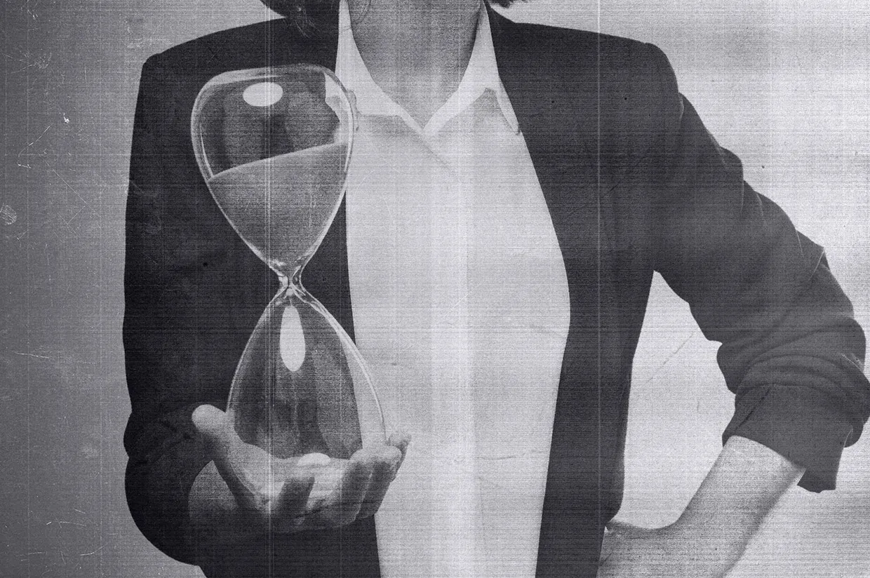 a business woman holding an hourglass