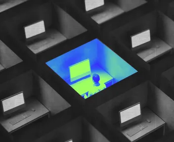 3D illustration of cubicles with computer workstations highlighting one lit and occupied cubicle in blue with a person inside.