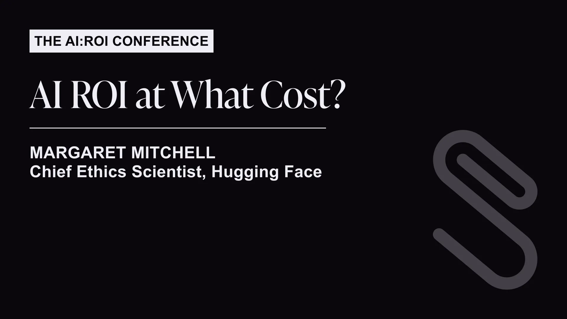 The AI:ROI Conference slide titled 'AI ROI at What Cost?' featuring Margaret Mitchell, Chief Ethics Scientist at Hugging Face with a large paperclip graphic on black background.
