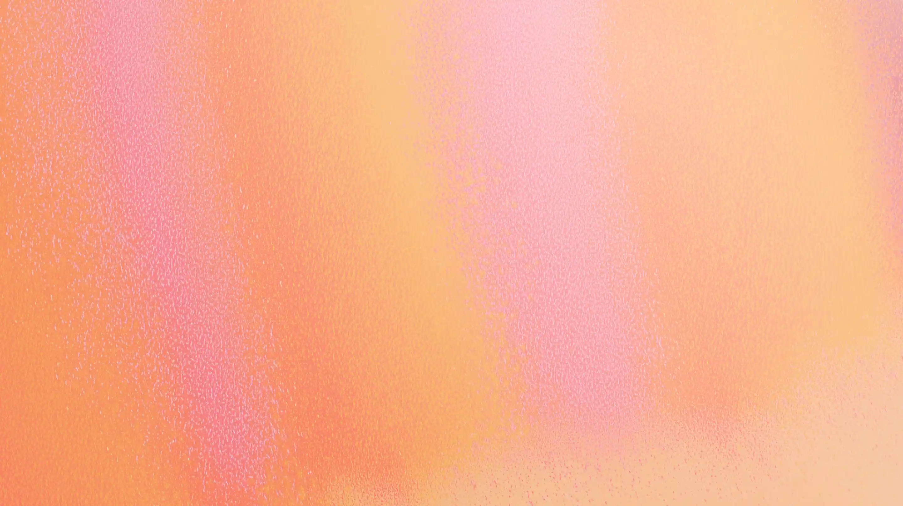 Abstract gradient background with soft pink and orange hues blending smoothly.