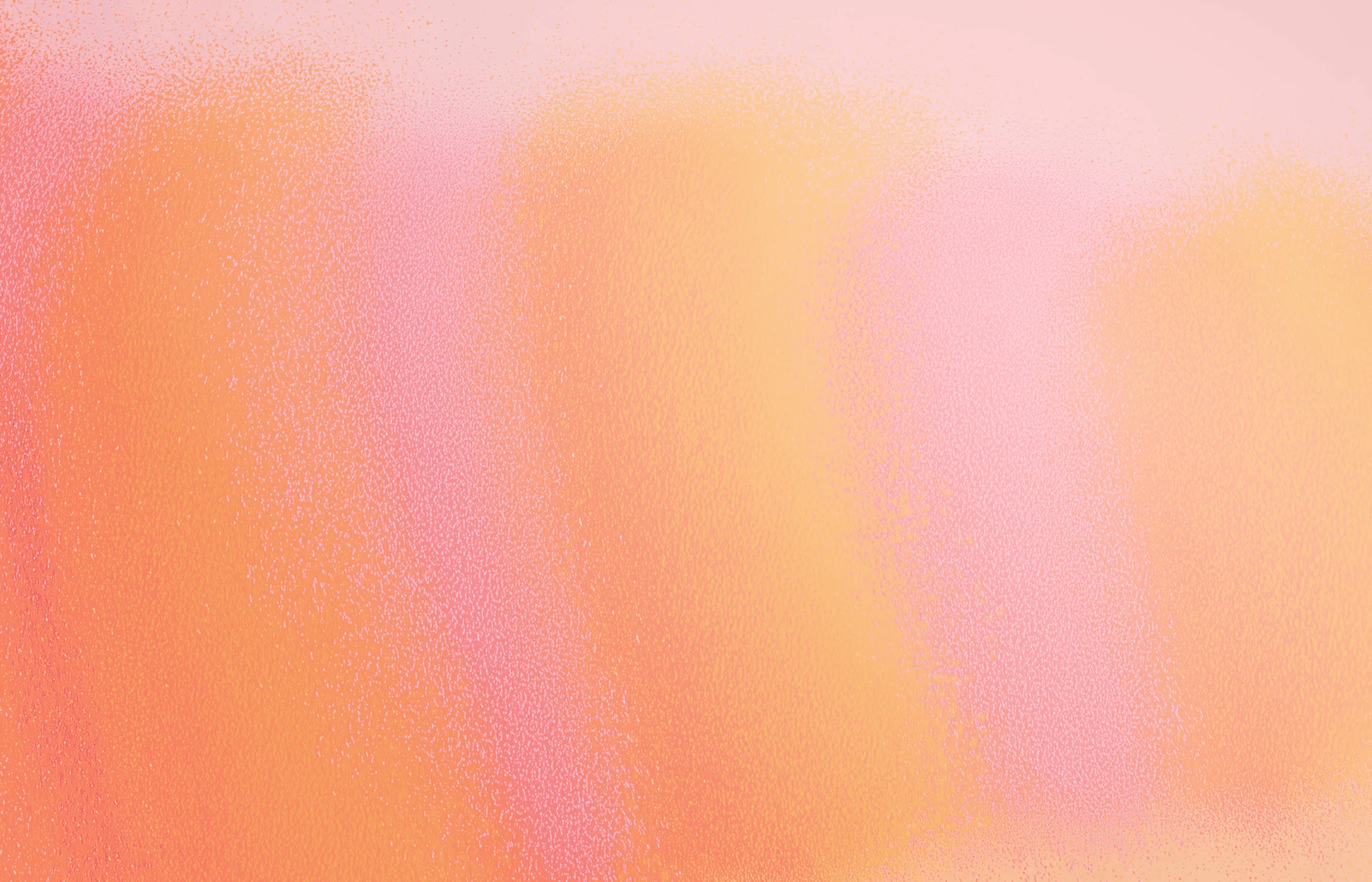 Abstract textured gradient background blending peach, pink, and orange hues.